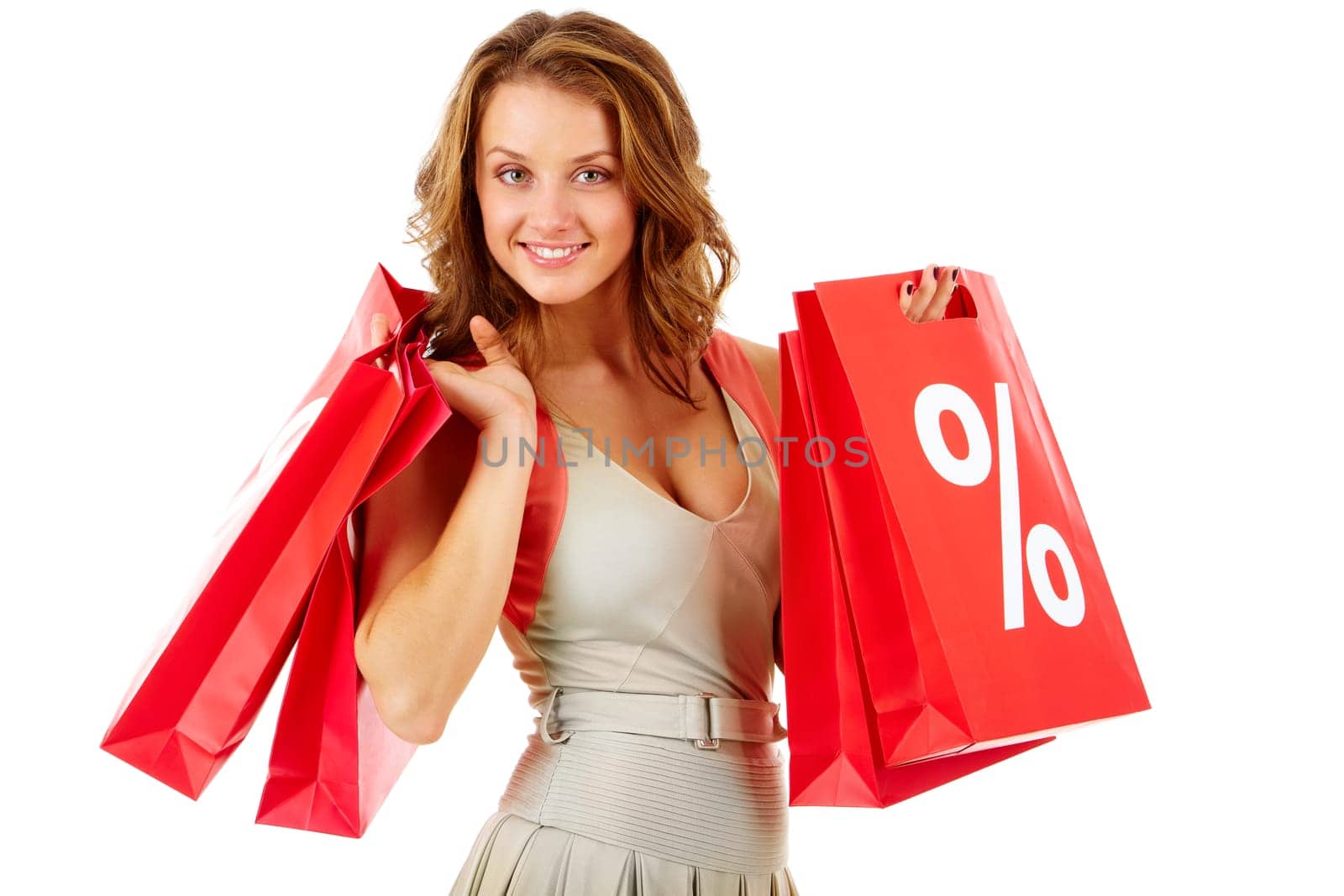 Portrait of a girl holding handbags with discount symbol, looking at camera and smiling