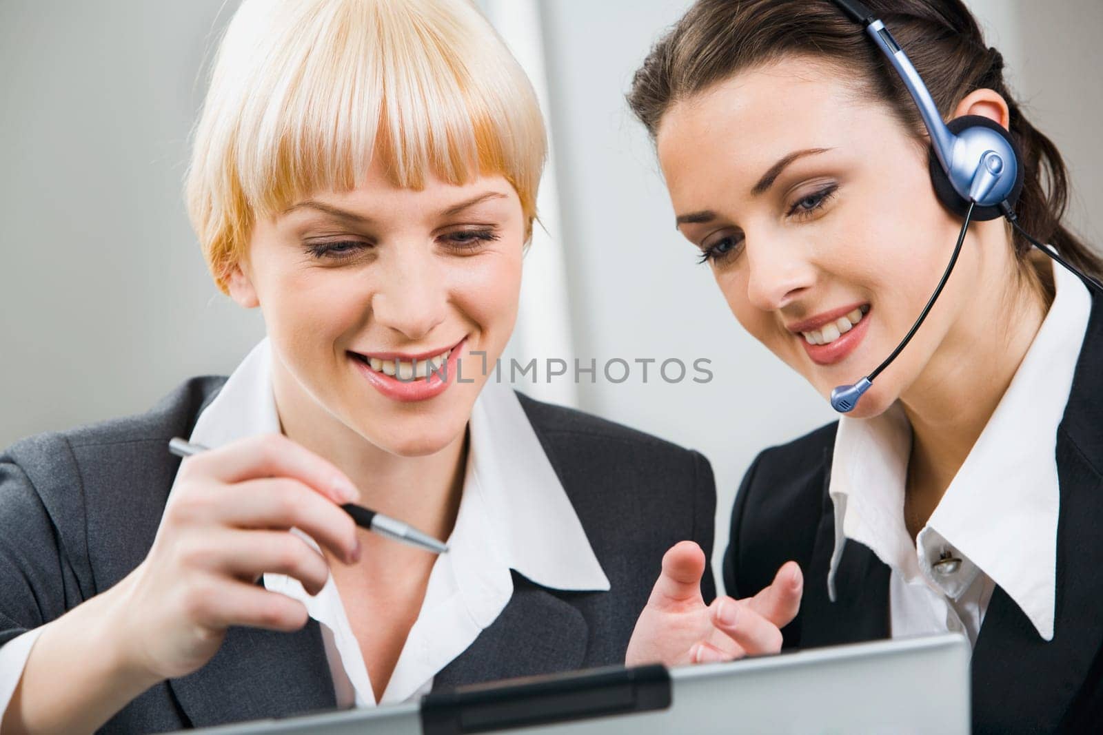 Portrait of two attractive business women working together