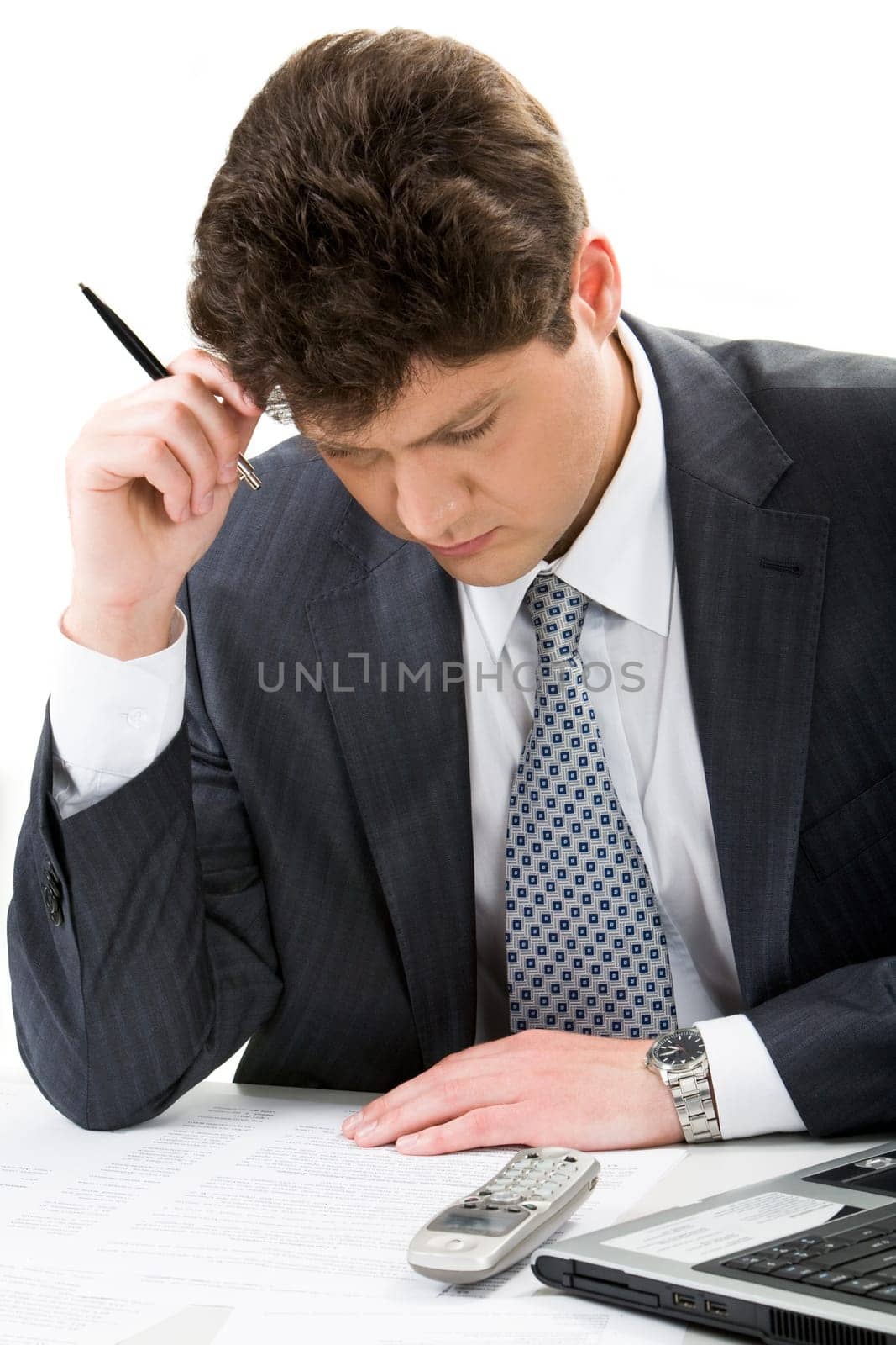 Portrait of serious businessman looking at plan while thinking about project
