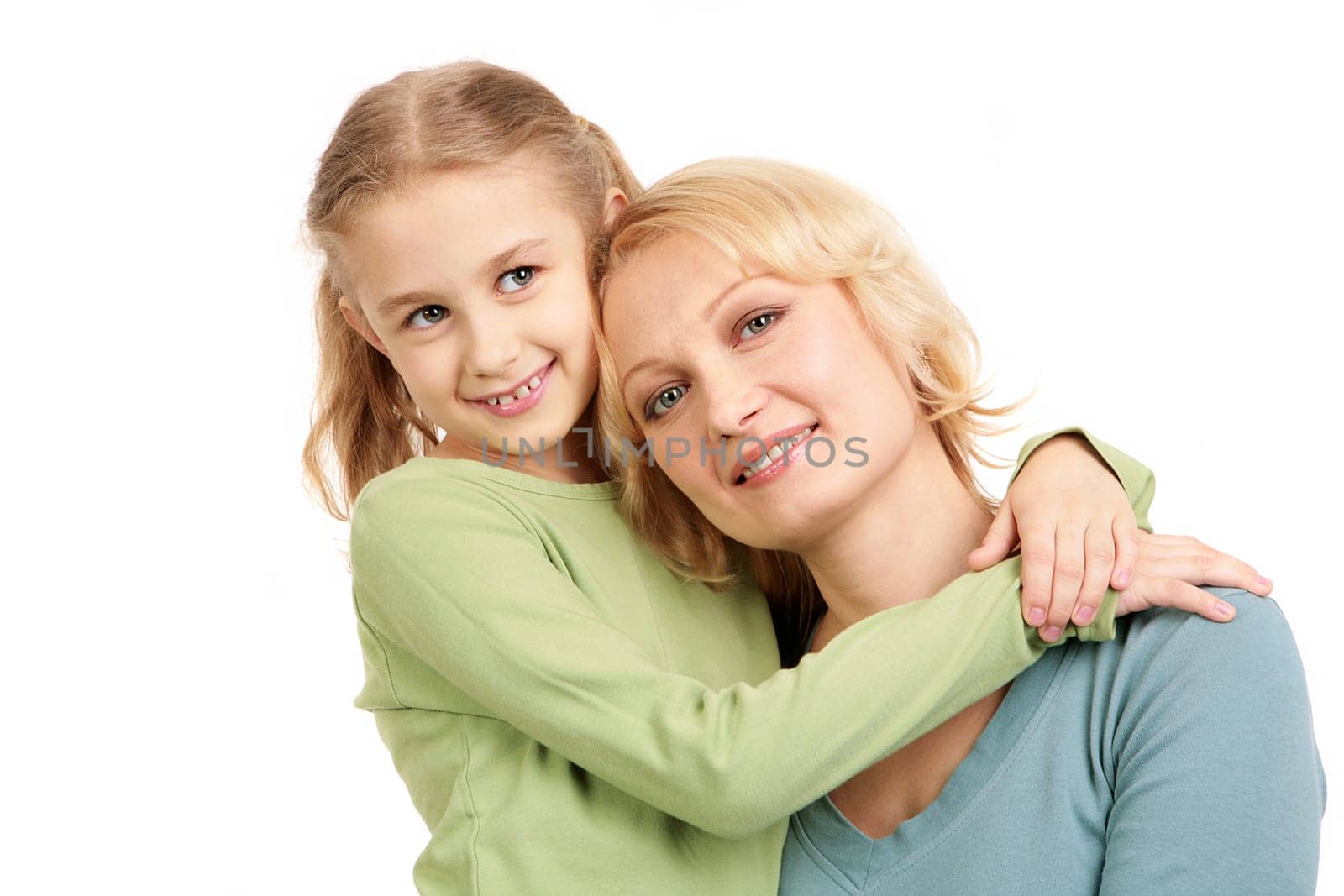 Portrait of little girl embracing woman wearing casual clothes