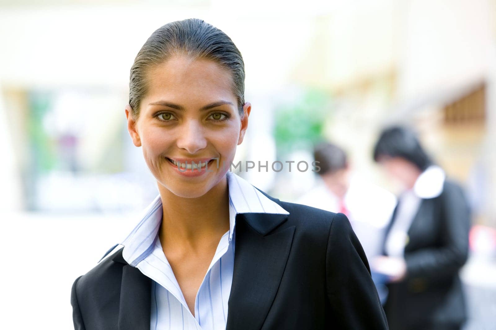 Portrait of young secretary smiling on the background of people
