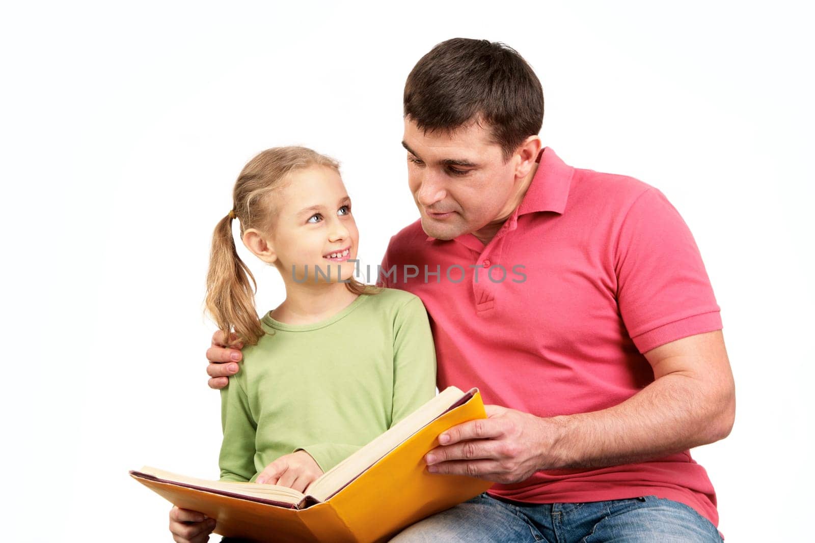 Portrait of loving father reading book together with his daughter