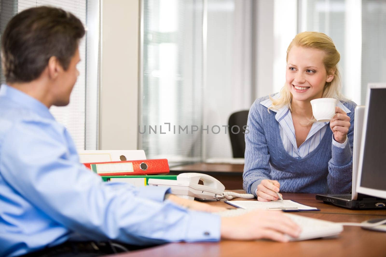 Image of secretary and boss communicating in the office while planning work