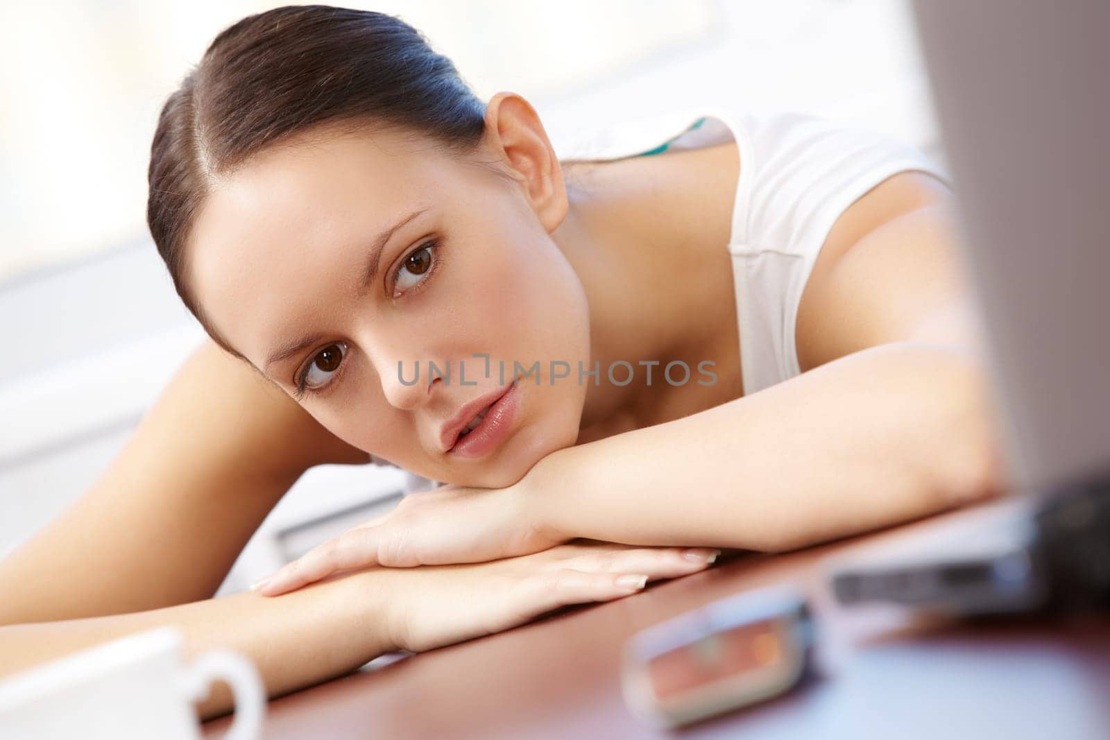 Portrait of pretty businesswoman looking at laptop screen in office