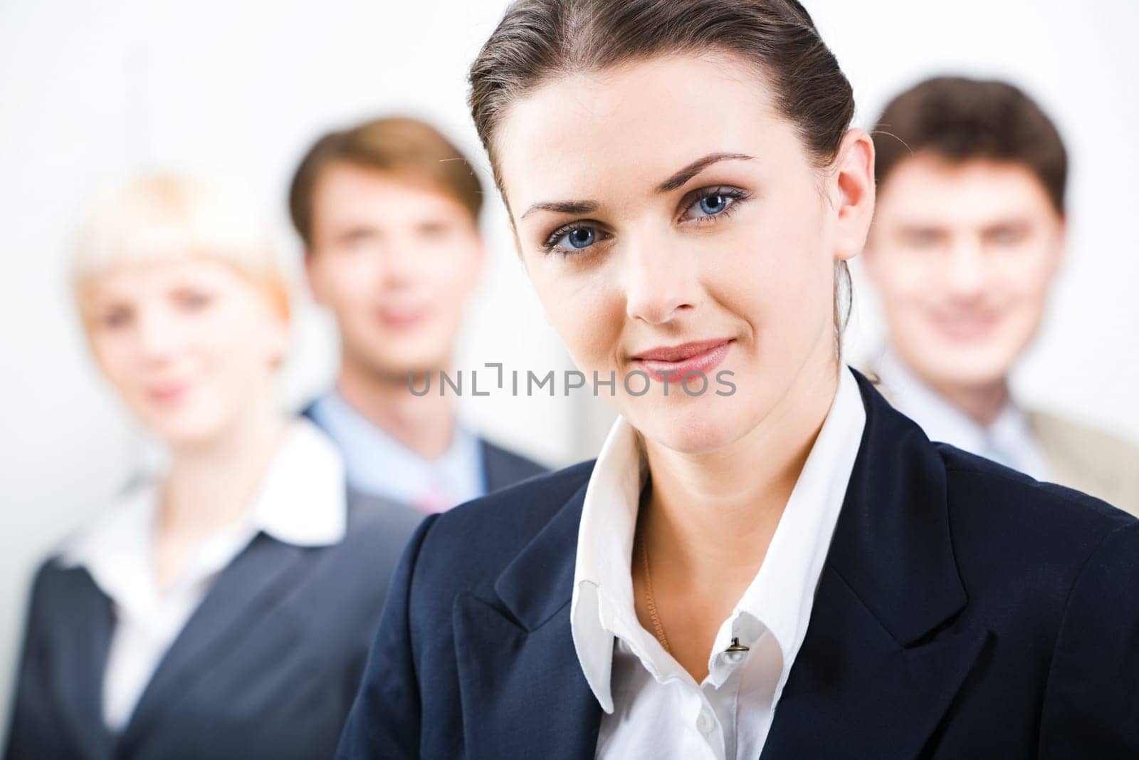 Photo of leader with her business team in the office