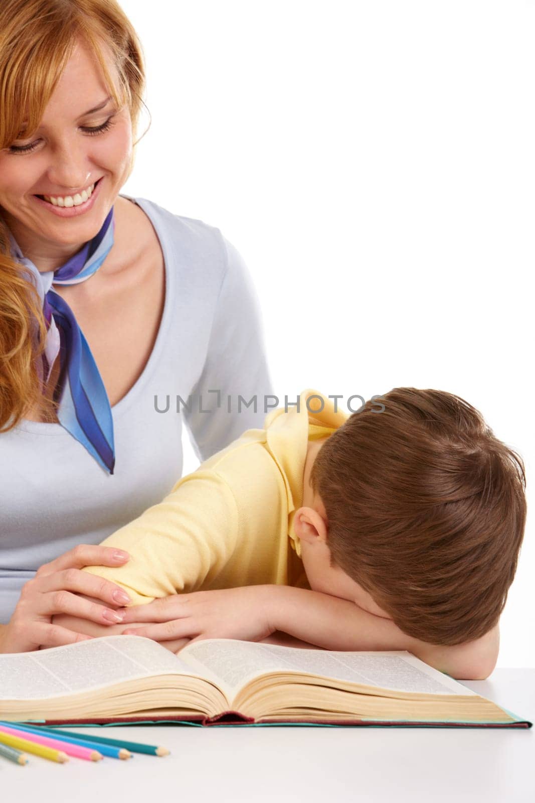 Portrait of little boy turning page of book with mother near by
