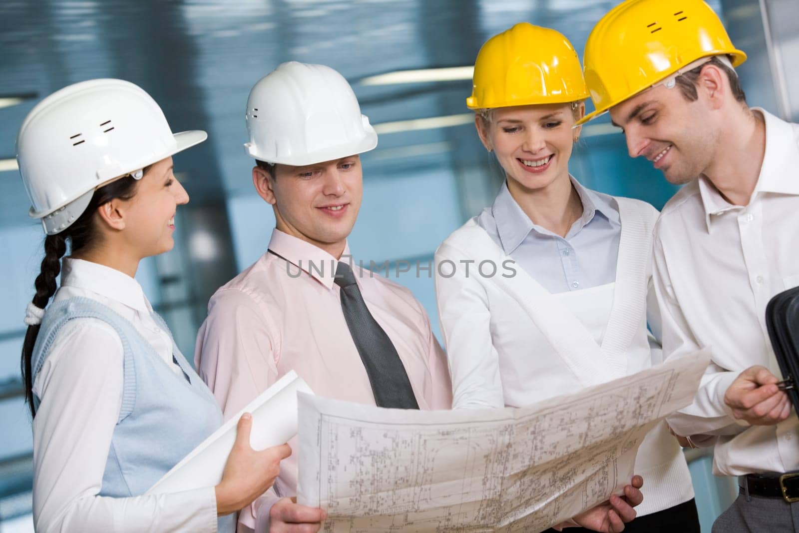 Portrait of confident architects in helmets planning their work