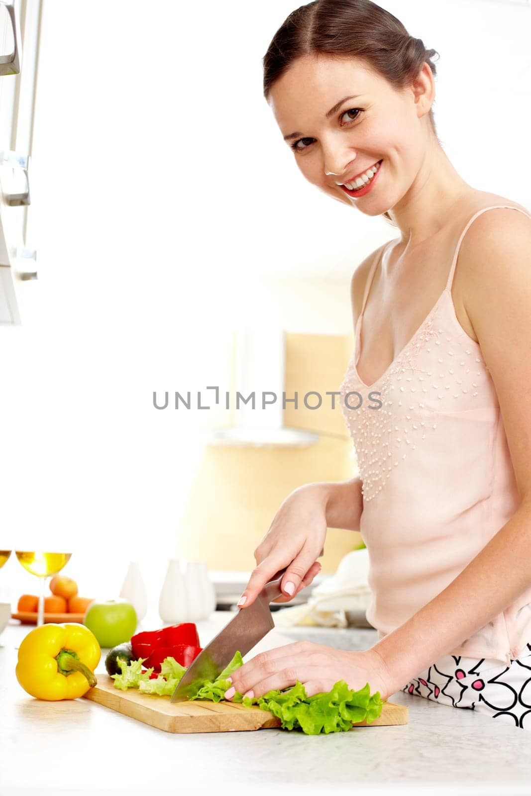 Portrait of happy female cooking vegetable salad