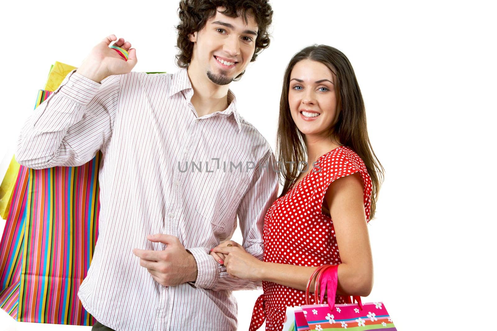 Portrait of happy couple with bags in hands on white background