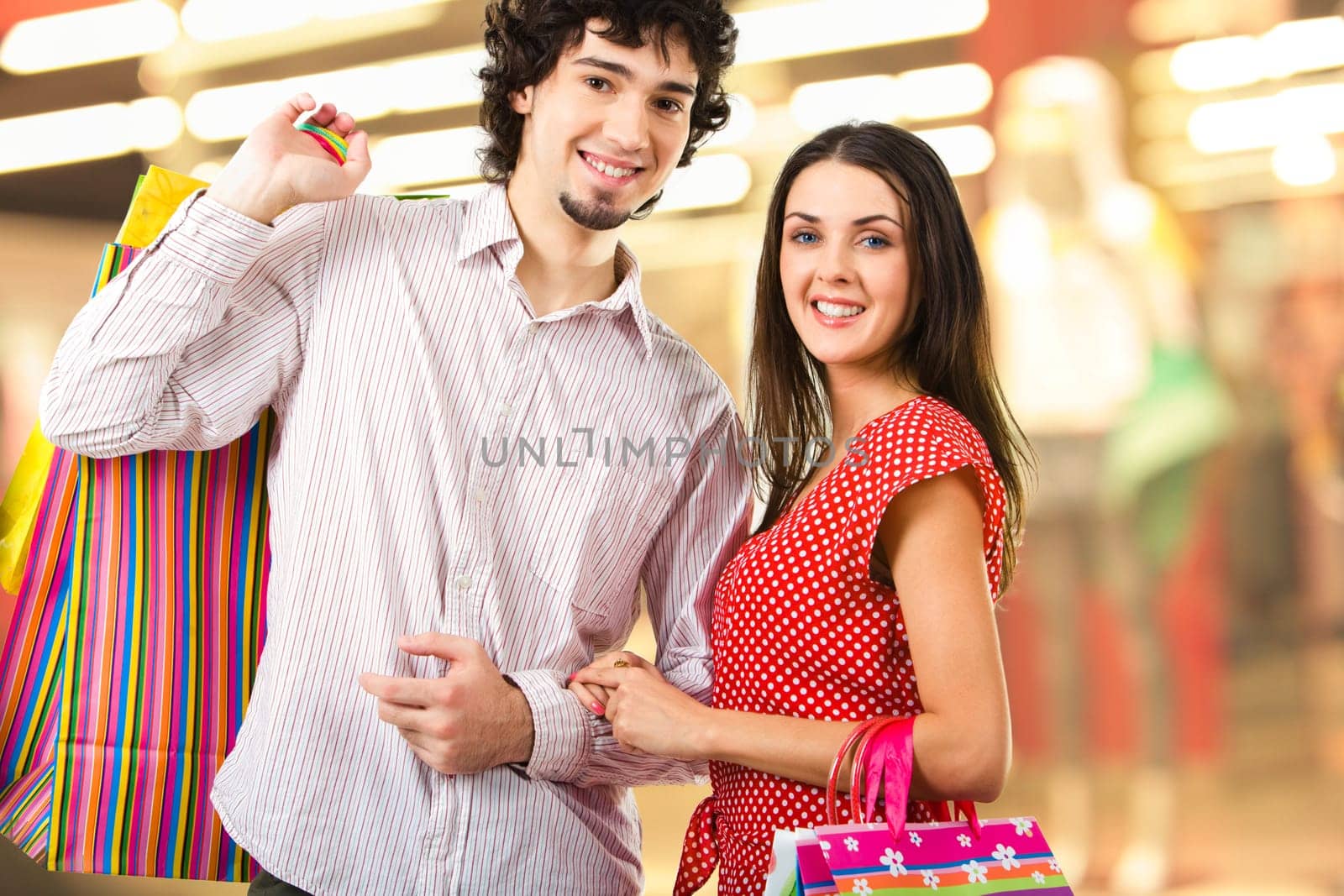 Image of two young people in the shopping mall looking at camera