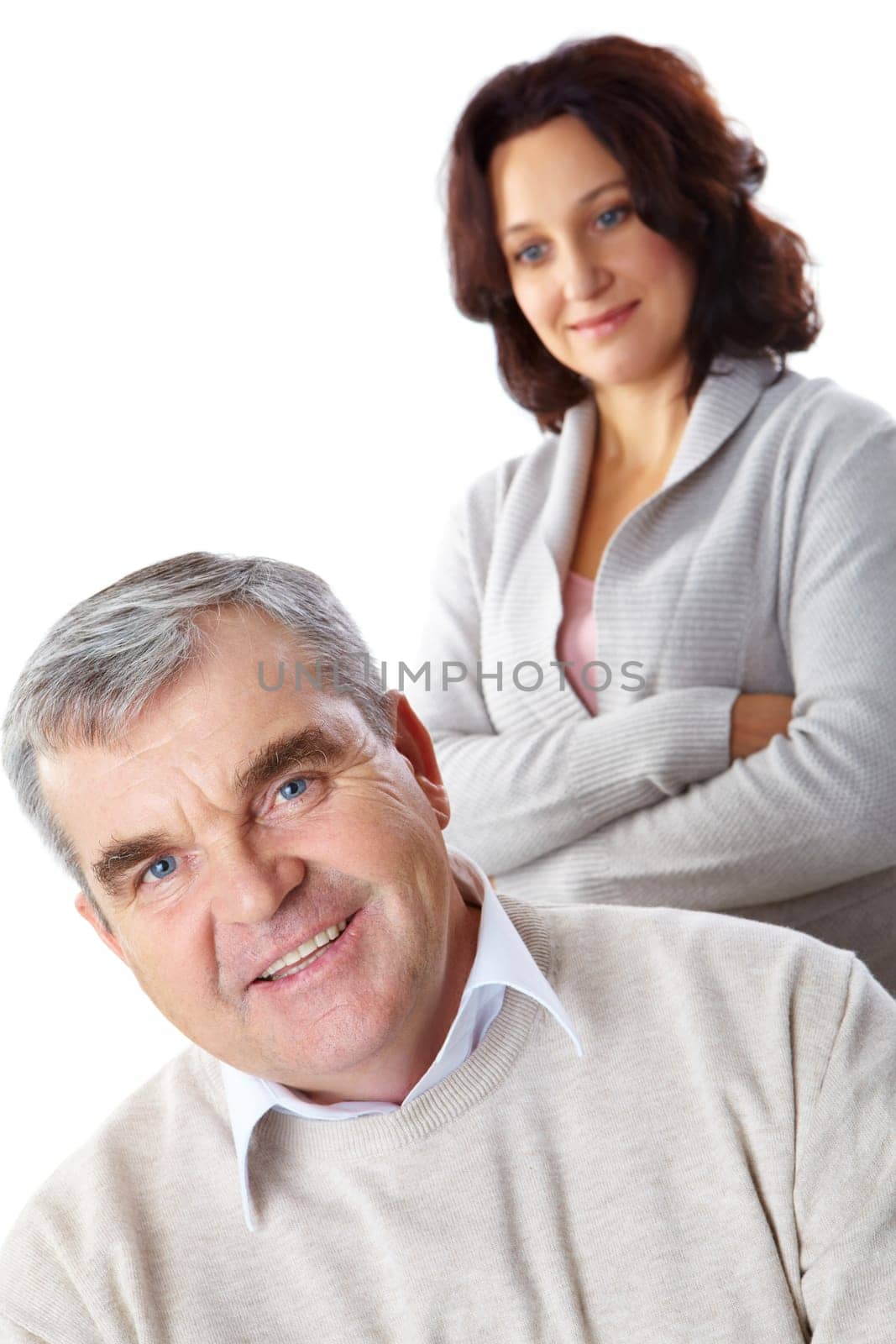 Portrait of happy mature man looking at camera with woman on background