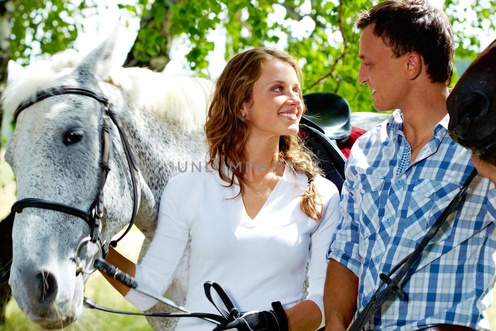 Image of happy couple of jockeys looking at each other