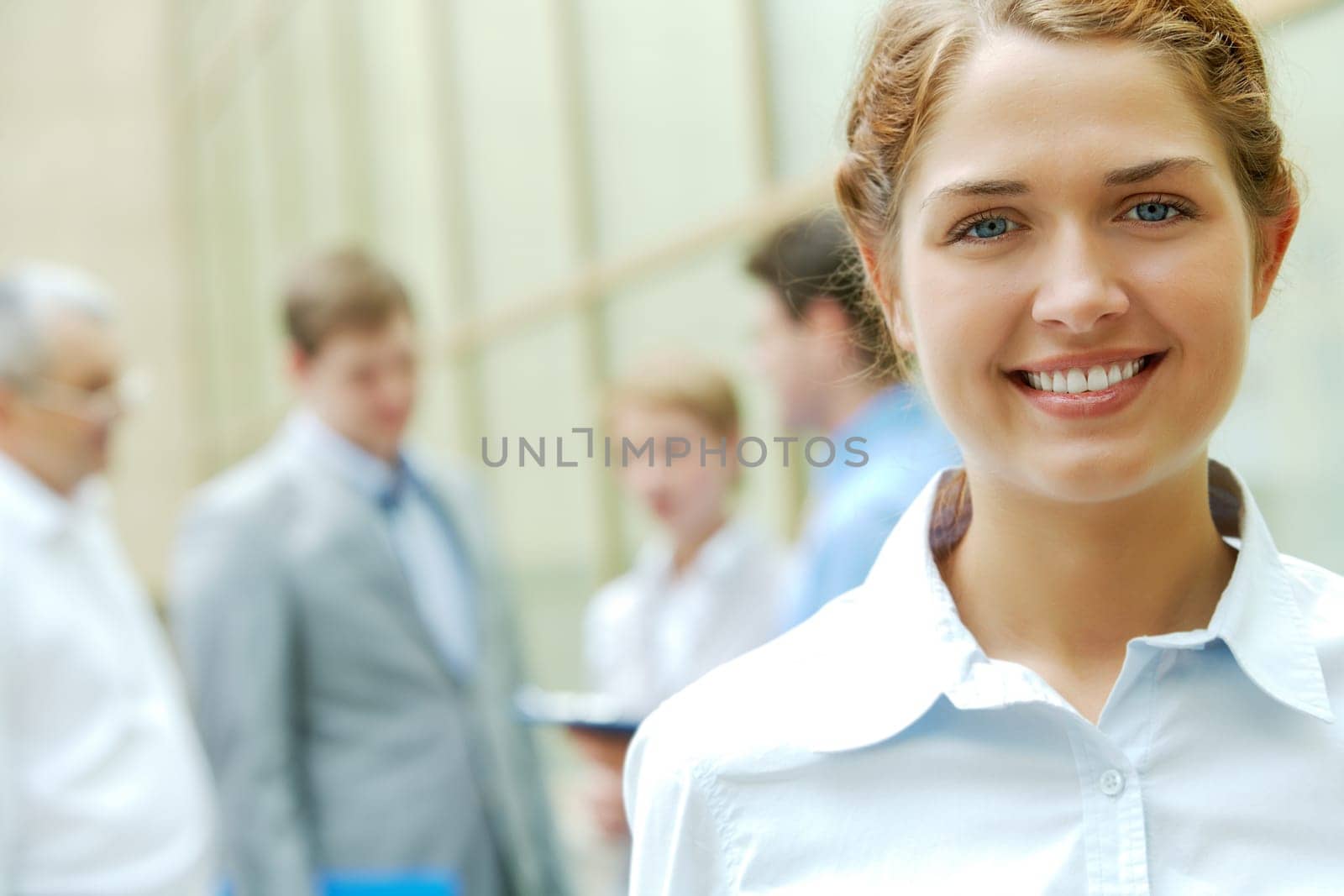 Portrait of pretty leader smiling at camera in natural environment