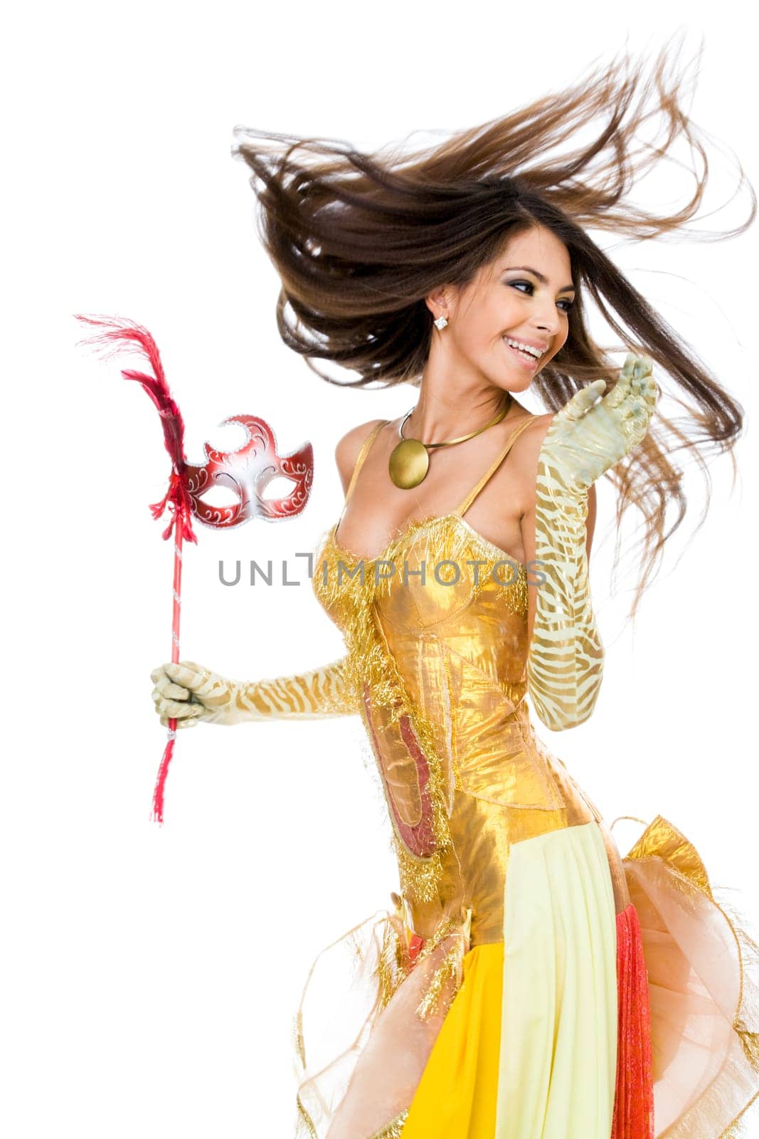 Portrait of playful woman in glamorous attire and mask in hand