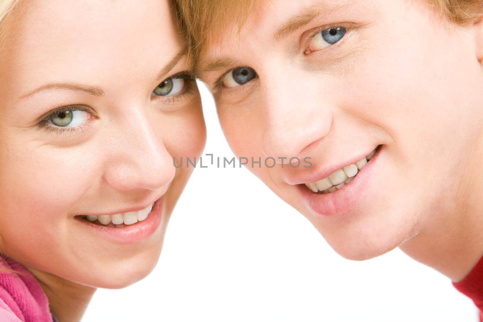 Happy faces of young girl and guy looking at camera and smiling