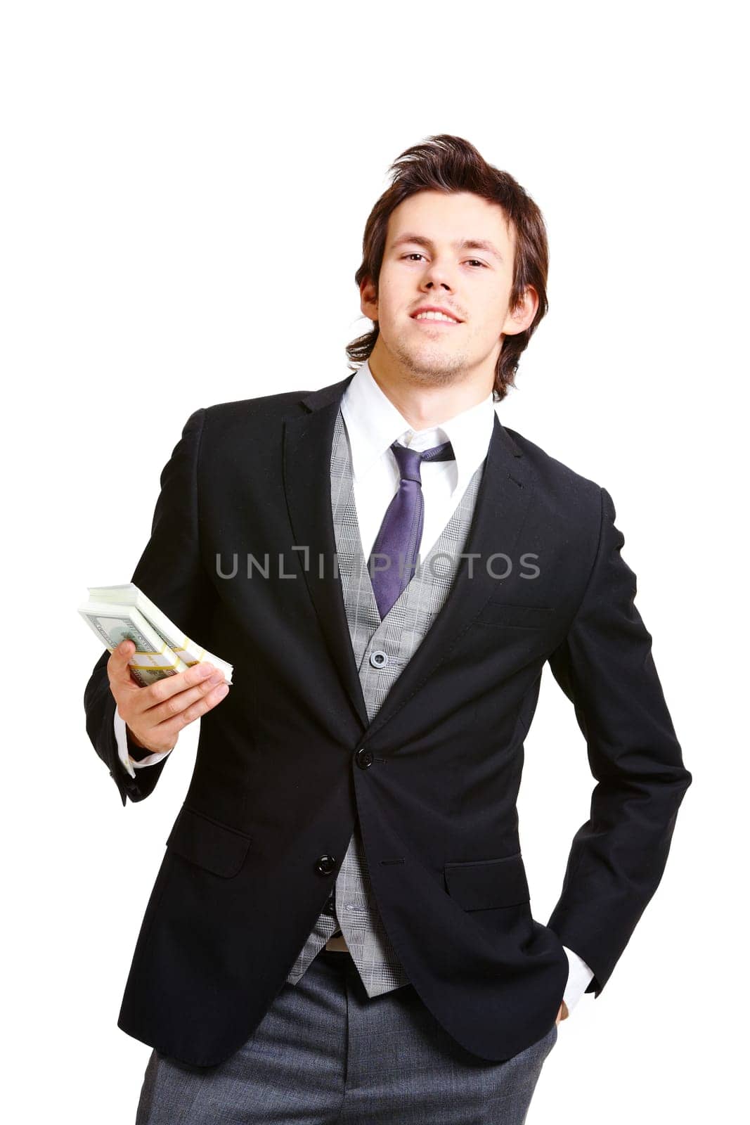 Portrait of successful businessman in elegant suit holding dollars