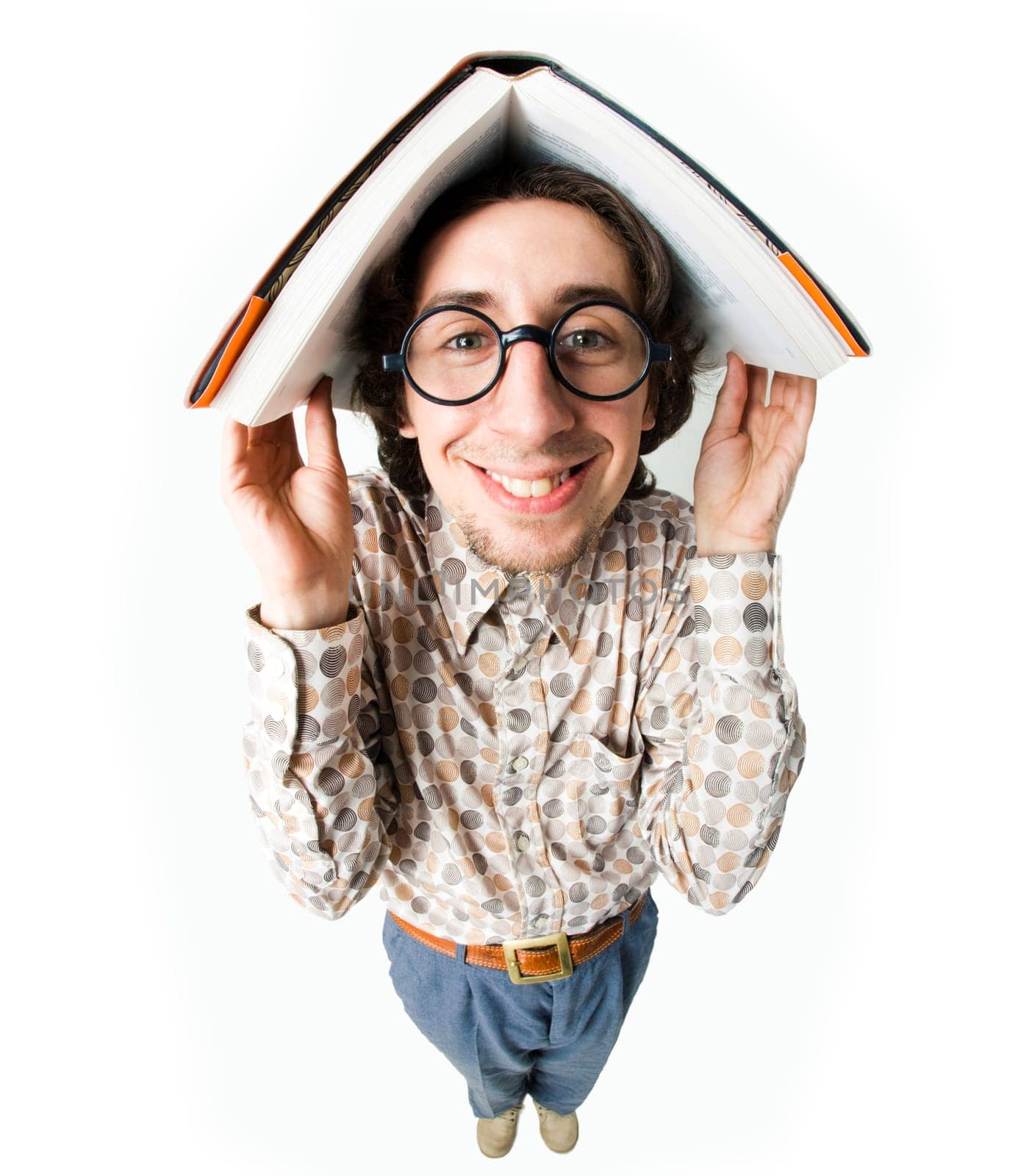 Fish-eye shot of intelligent guy holding book on his head and smiling