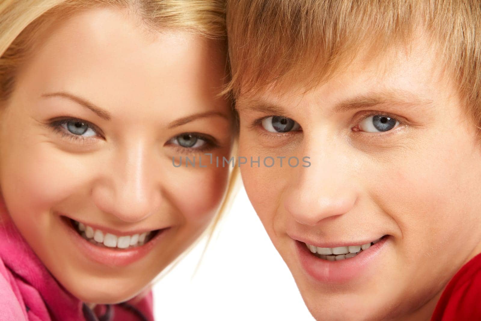 Happy faces of young girl and guy looking at camera and smiling