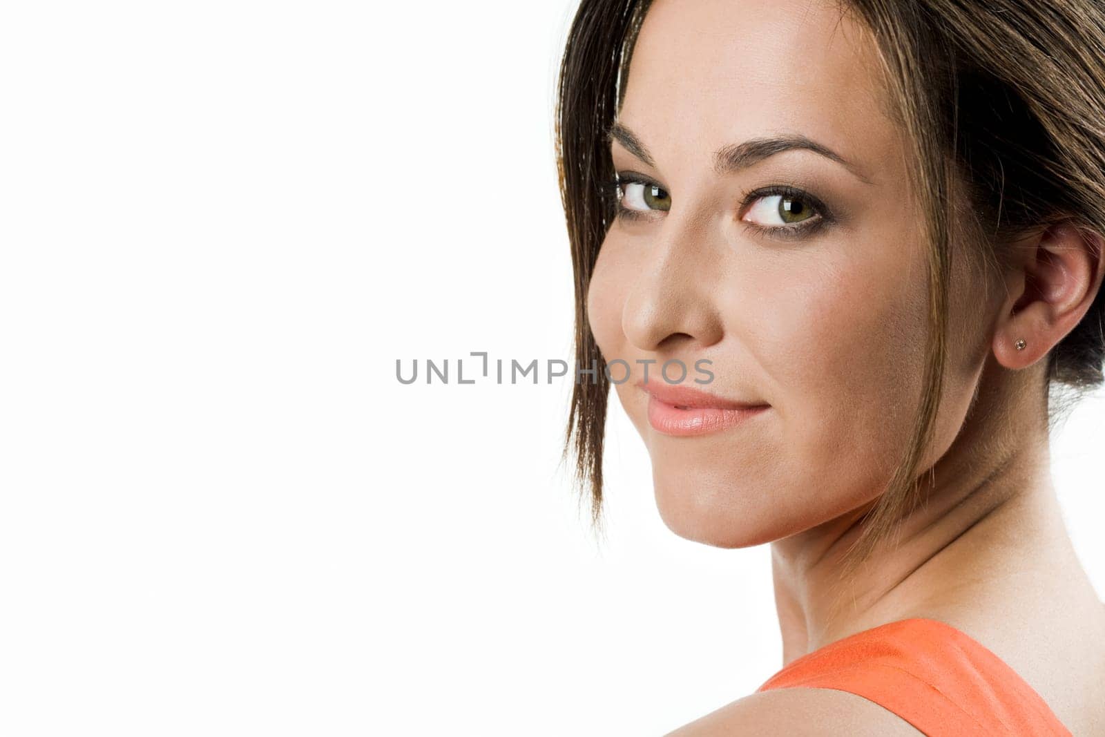 Face of pretty girl looking at camera with smile over white background