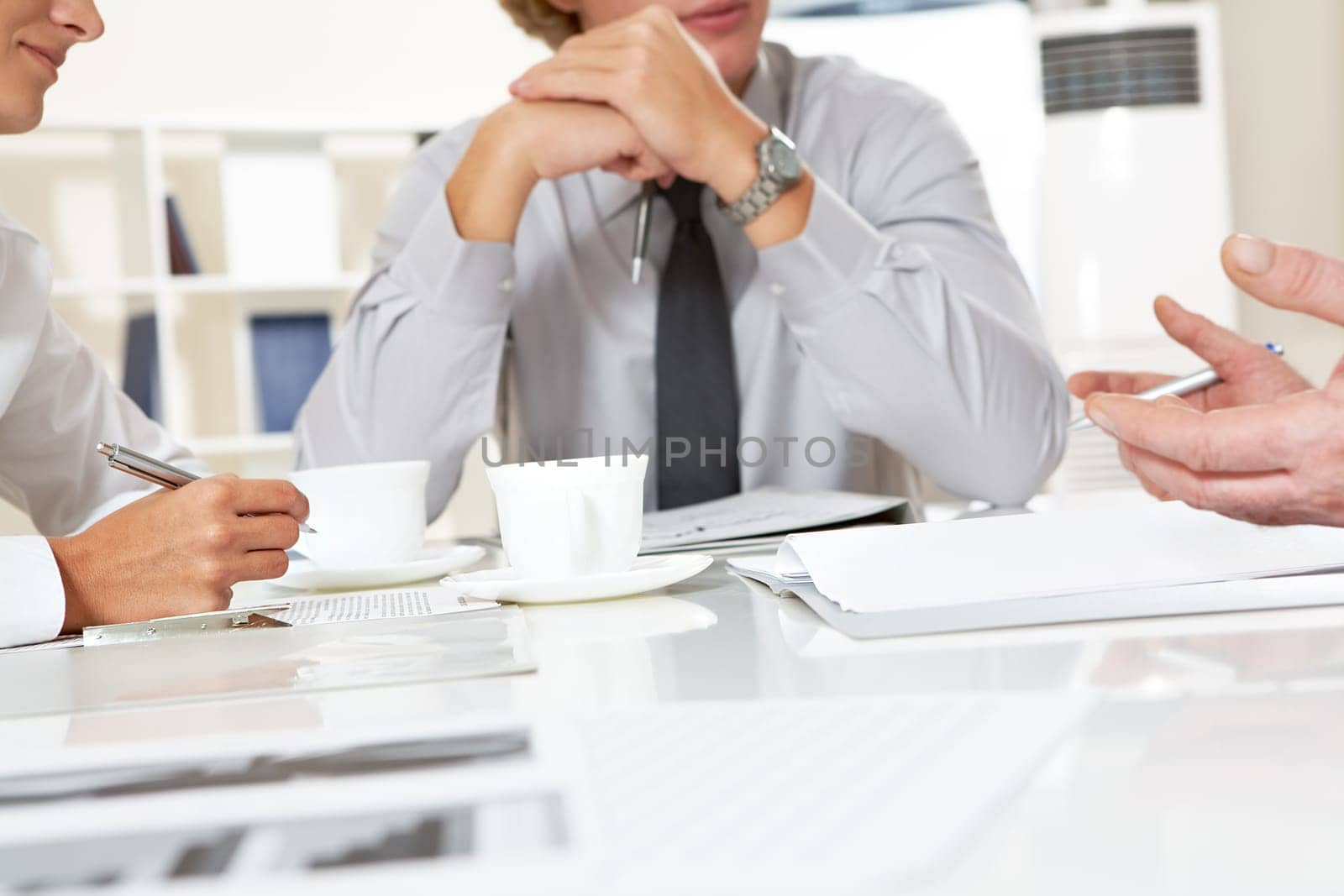 Close-up of businesspeople discussing plan at meeting