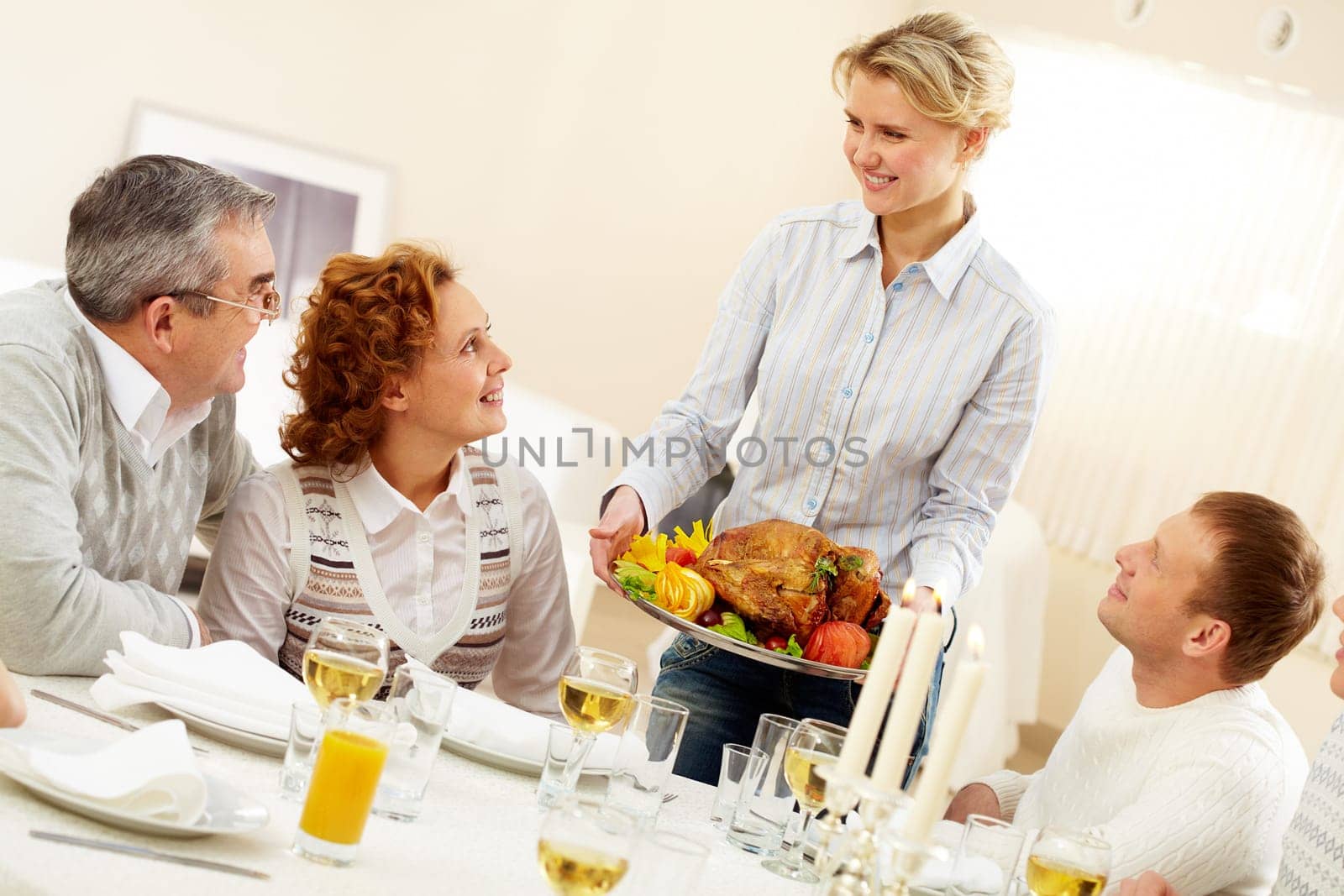 Portrait of senior couple and happy man pretty woman with roasted turkey going to put it on festive table