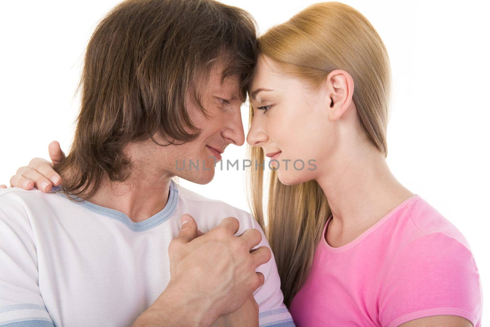 Portrait of loving couple looking at each other over white background