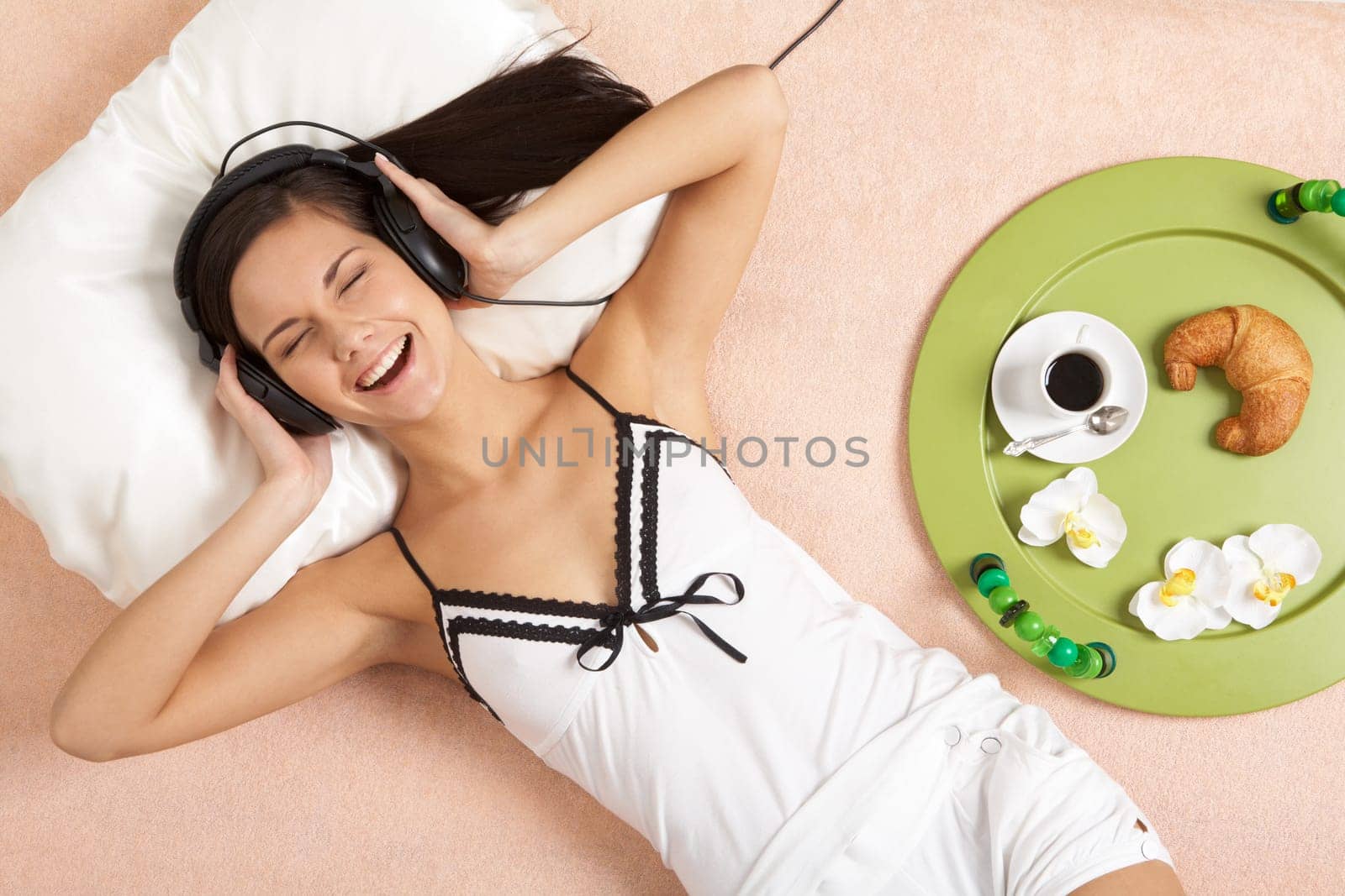 Pretty girl listening to music in headphones and taking pleasure in it