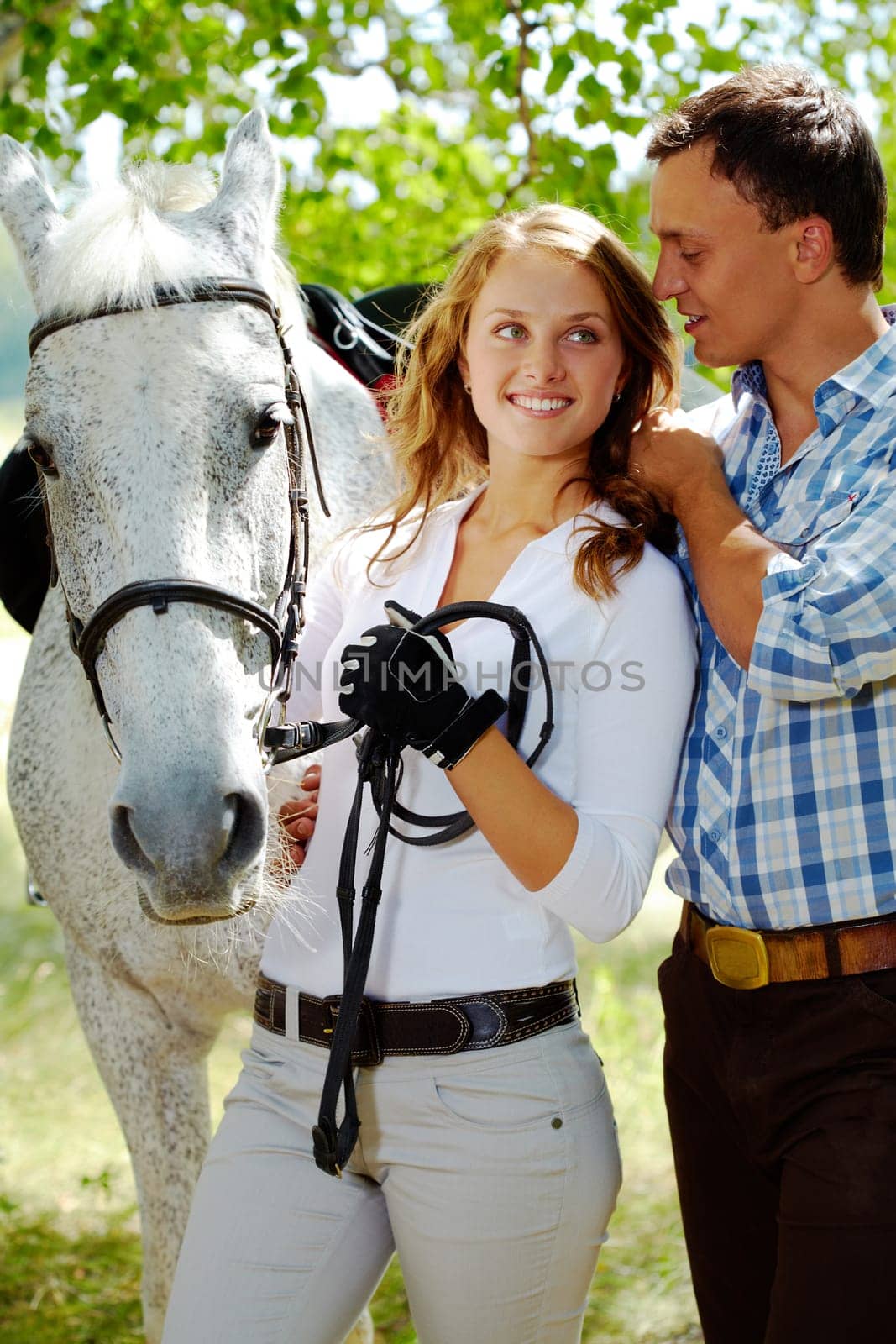 Image of happy woman between purebred horse and her sweetheart outside
