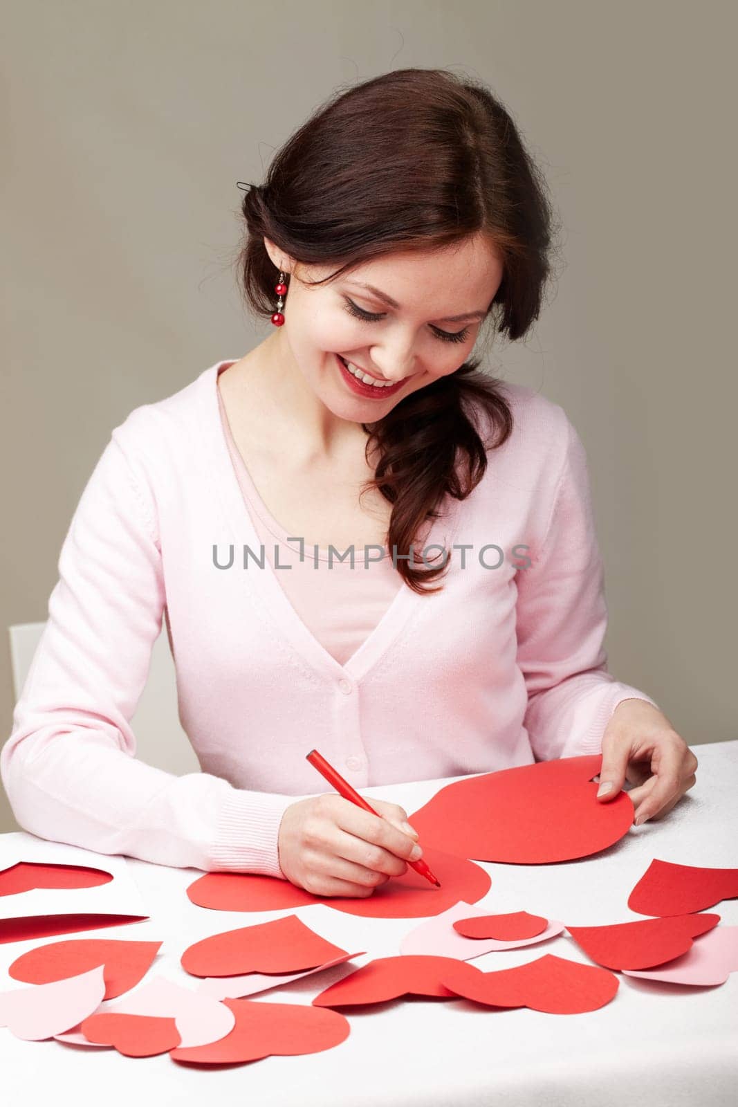 Portrait of a woman signing valentine cards