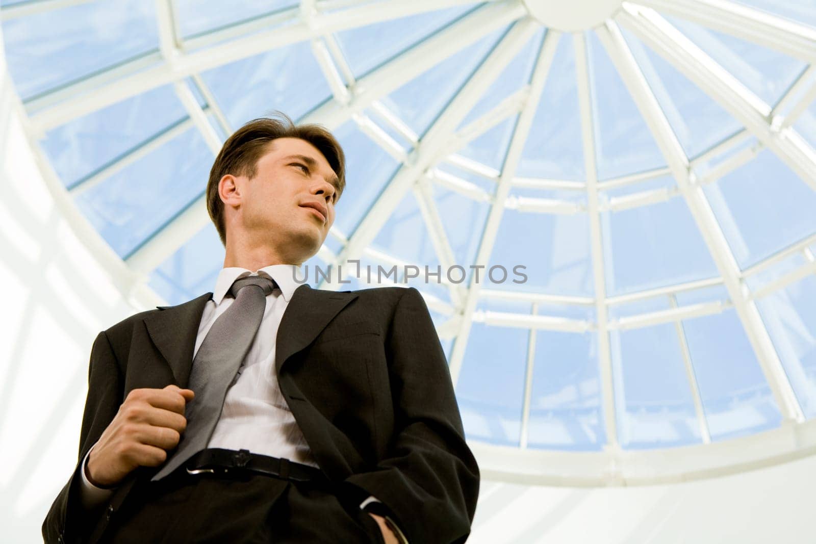 Below view of confident businessman looking aside