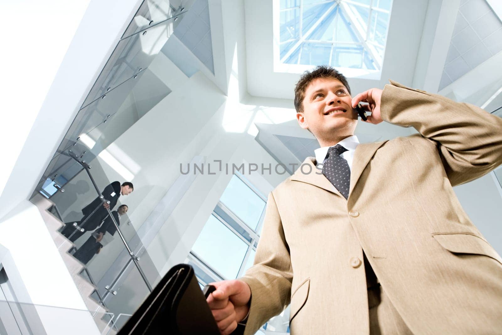 Image of busy successful man in suit in the modern office block