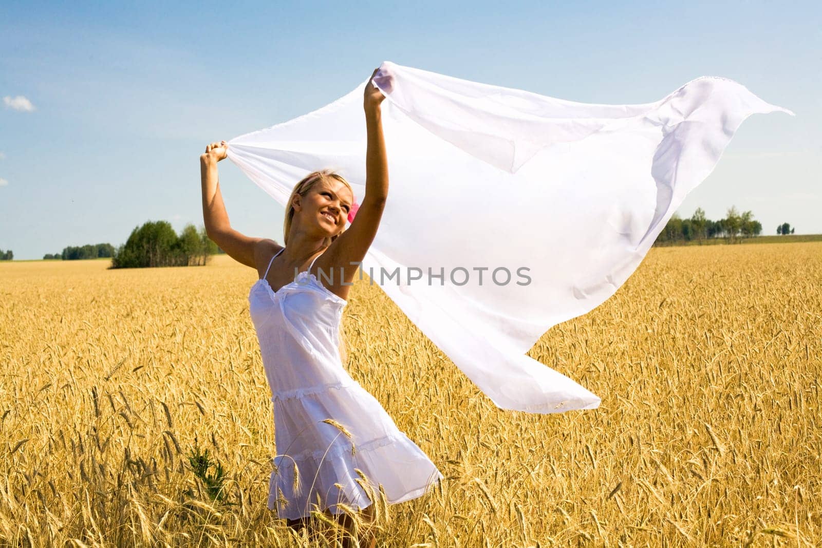 Image of happy female with white fabric in wheat meadow