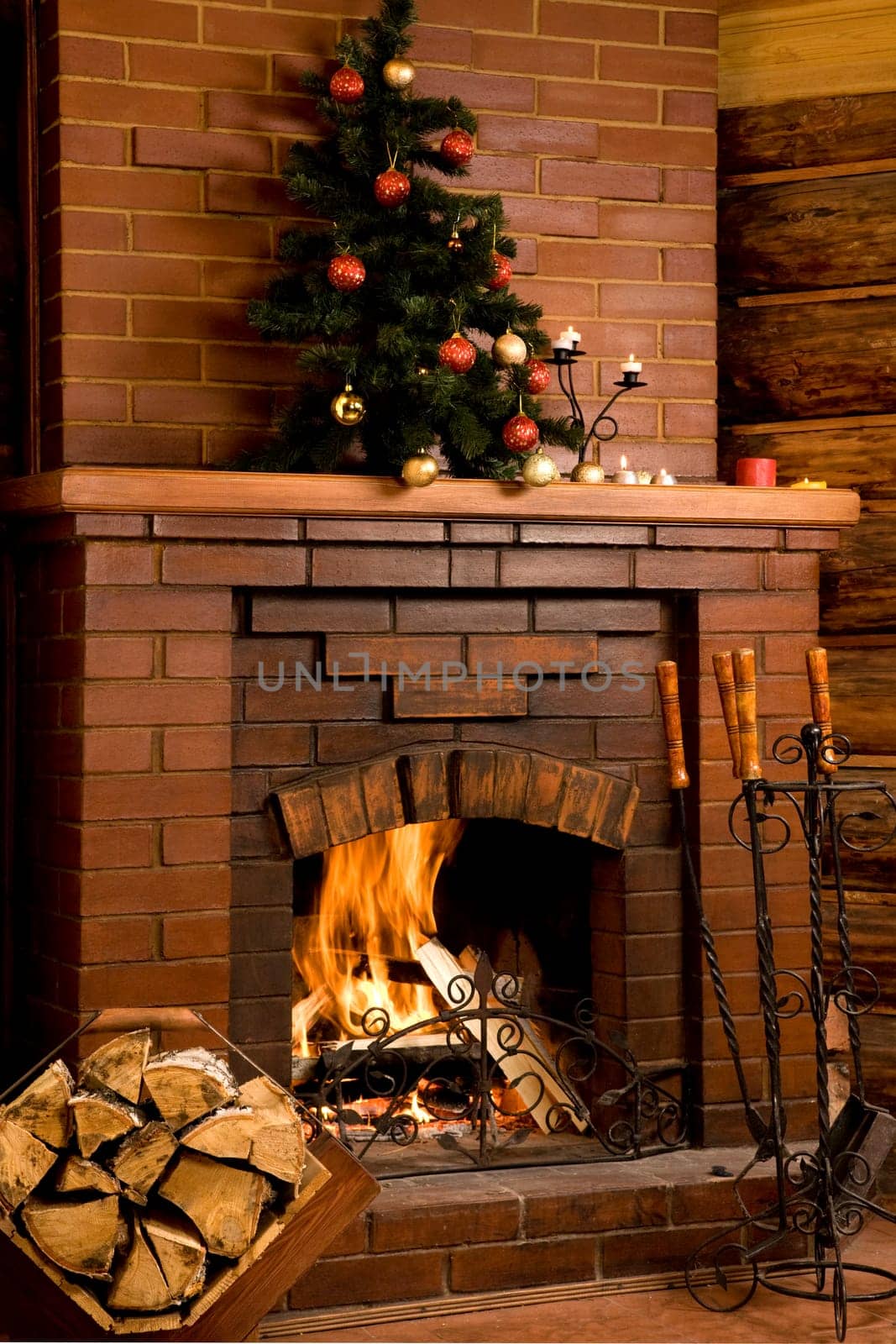 Image of chimney with fire inside and decorated tree on its top