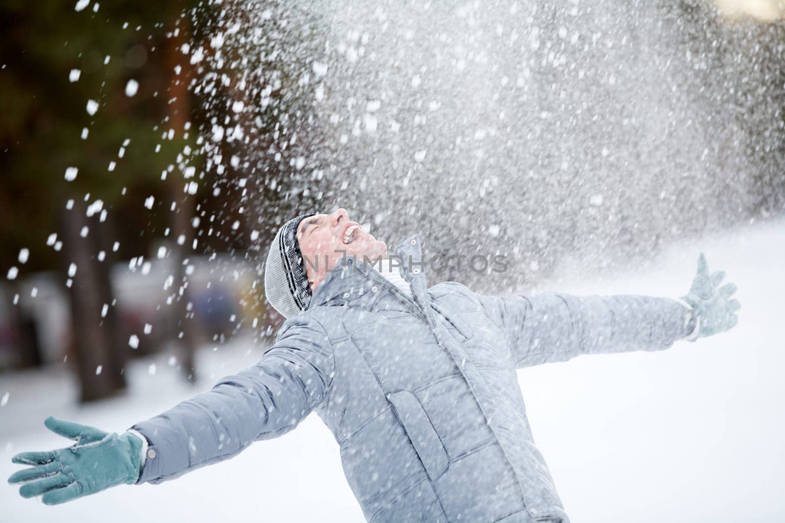 Portrait of cute guy taking pleasure on snowy winter day
