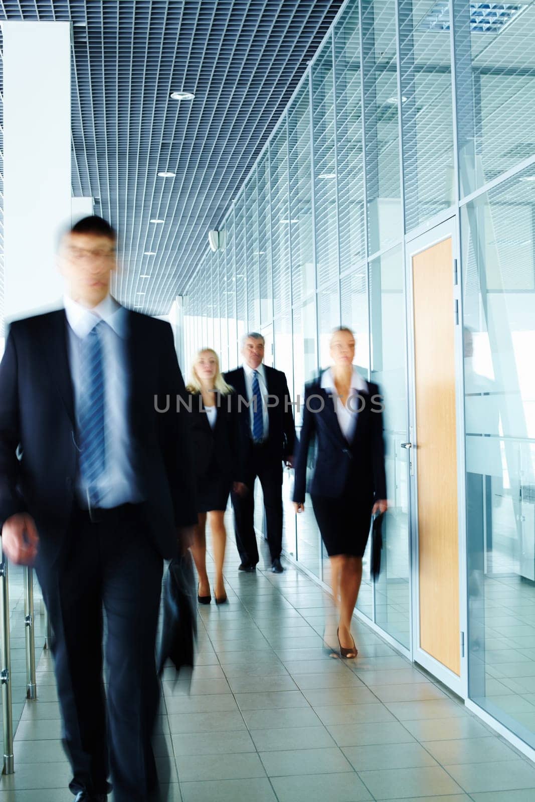 Businesspeople moving along the corridor