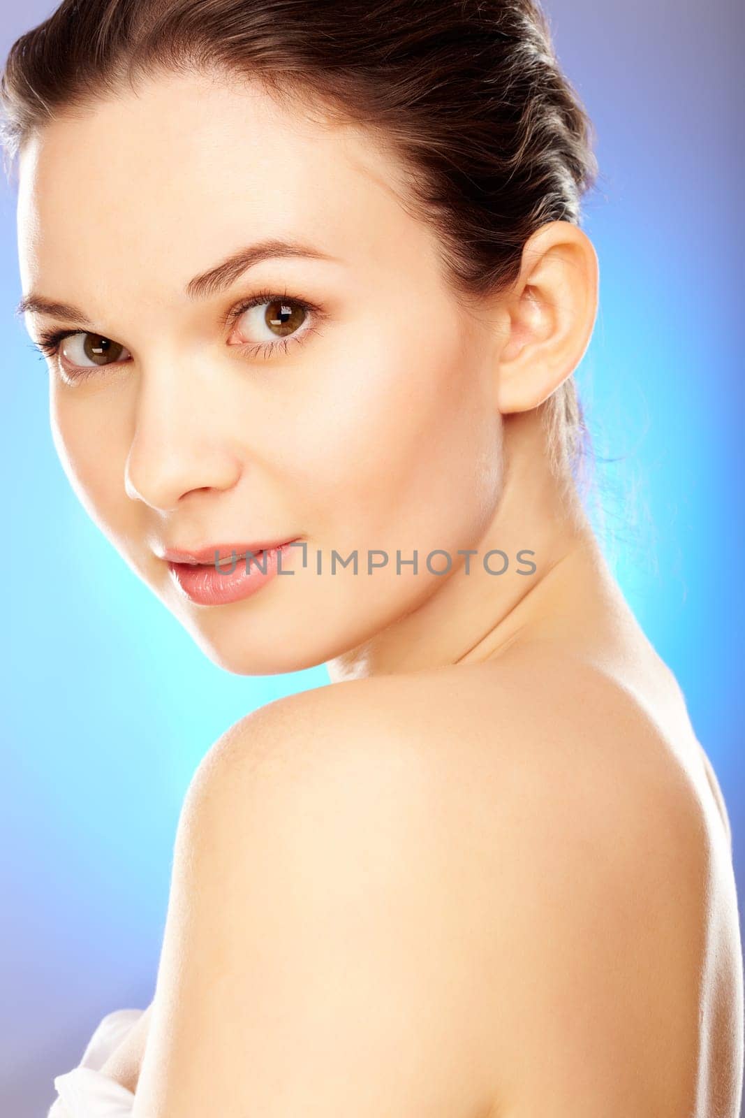 Elegant woman looking at camera over blue background