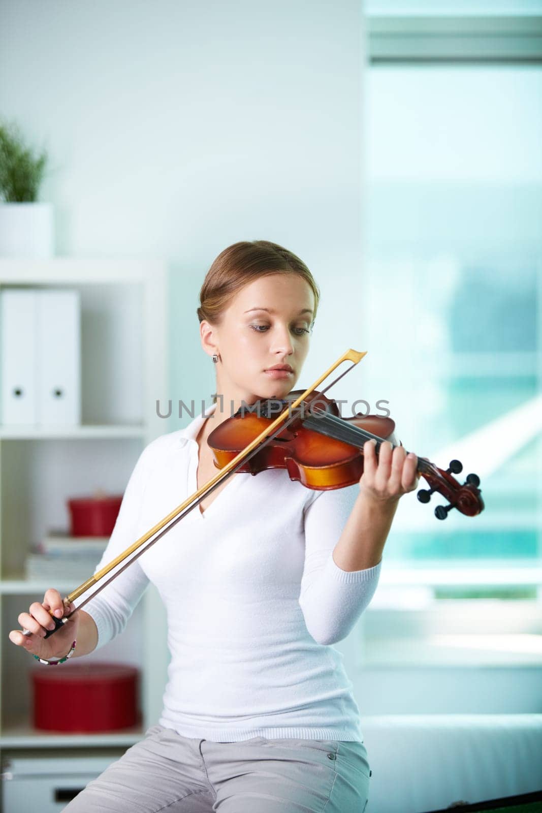 Portrait of a young female playing the violin