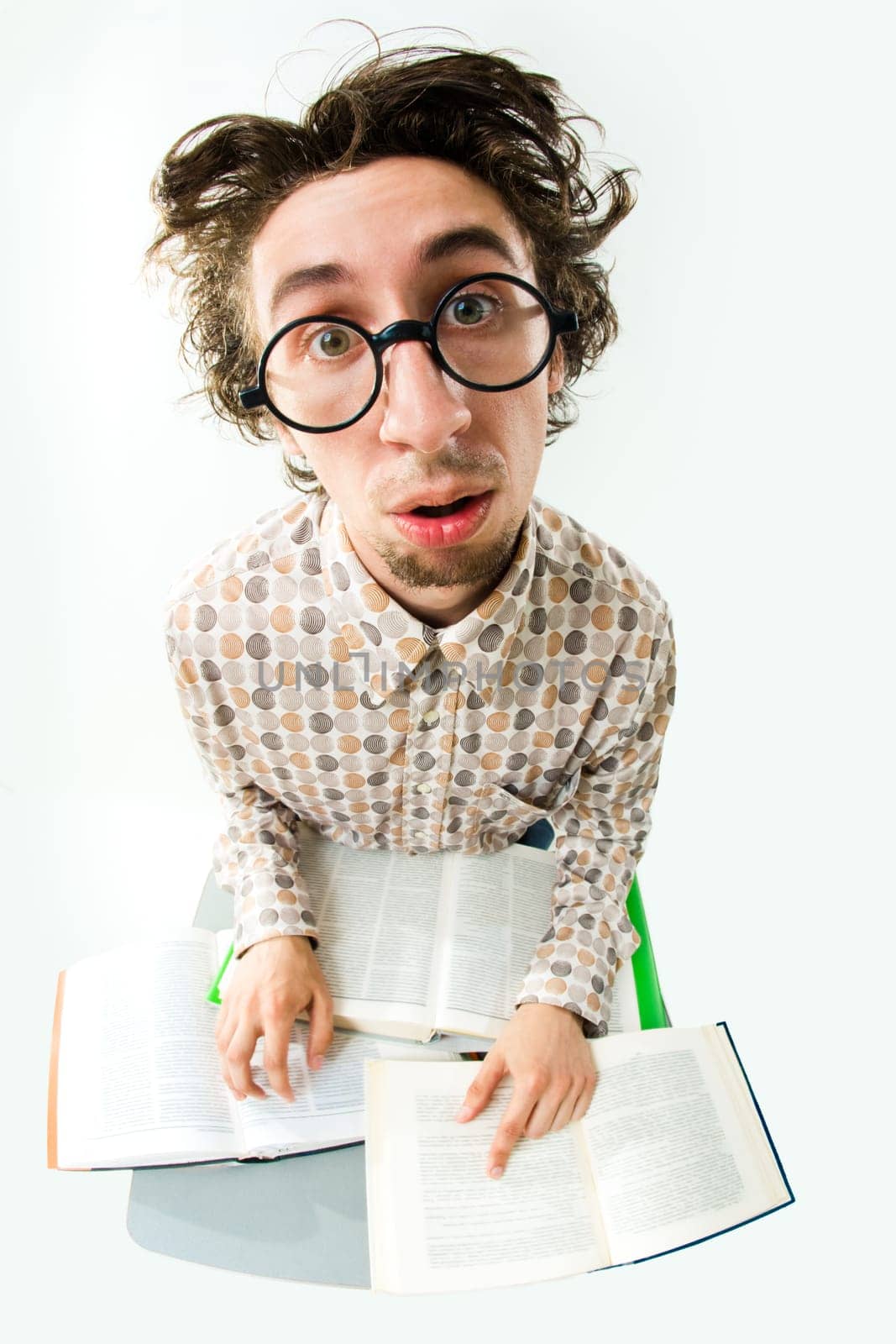 Image of tired student with glasses looking at camera