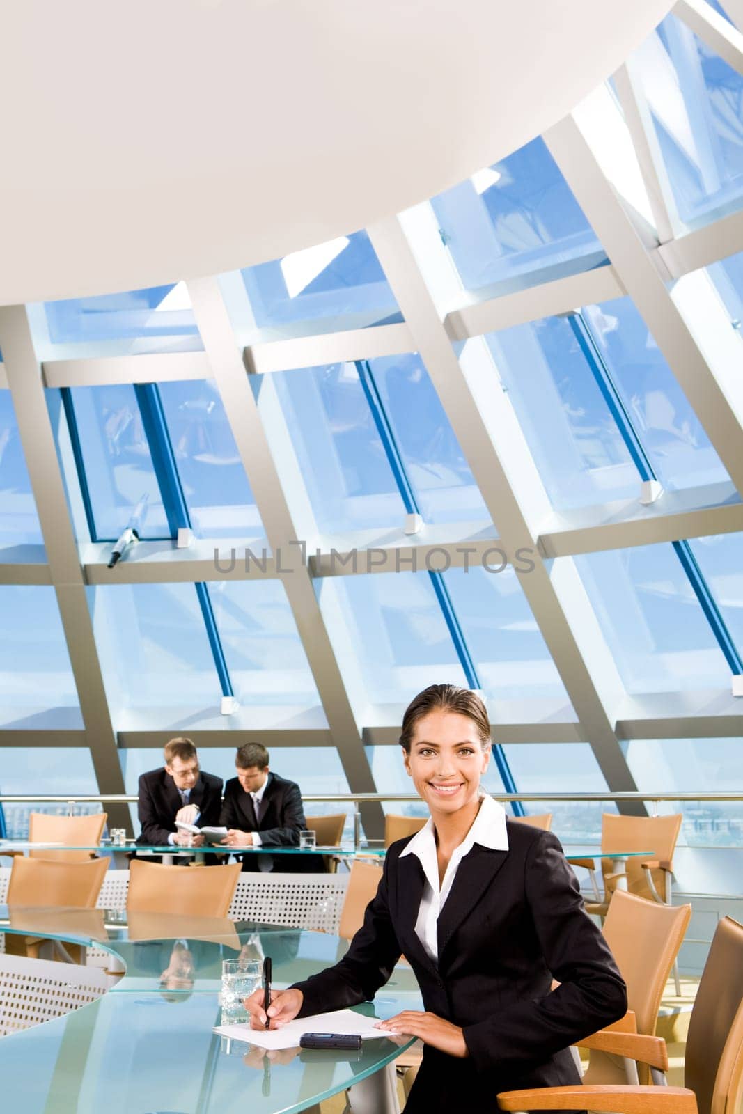 Confident woman sitting in the conference room and smiling
