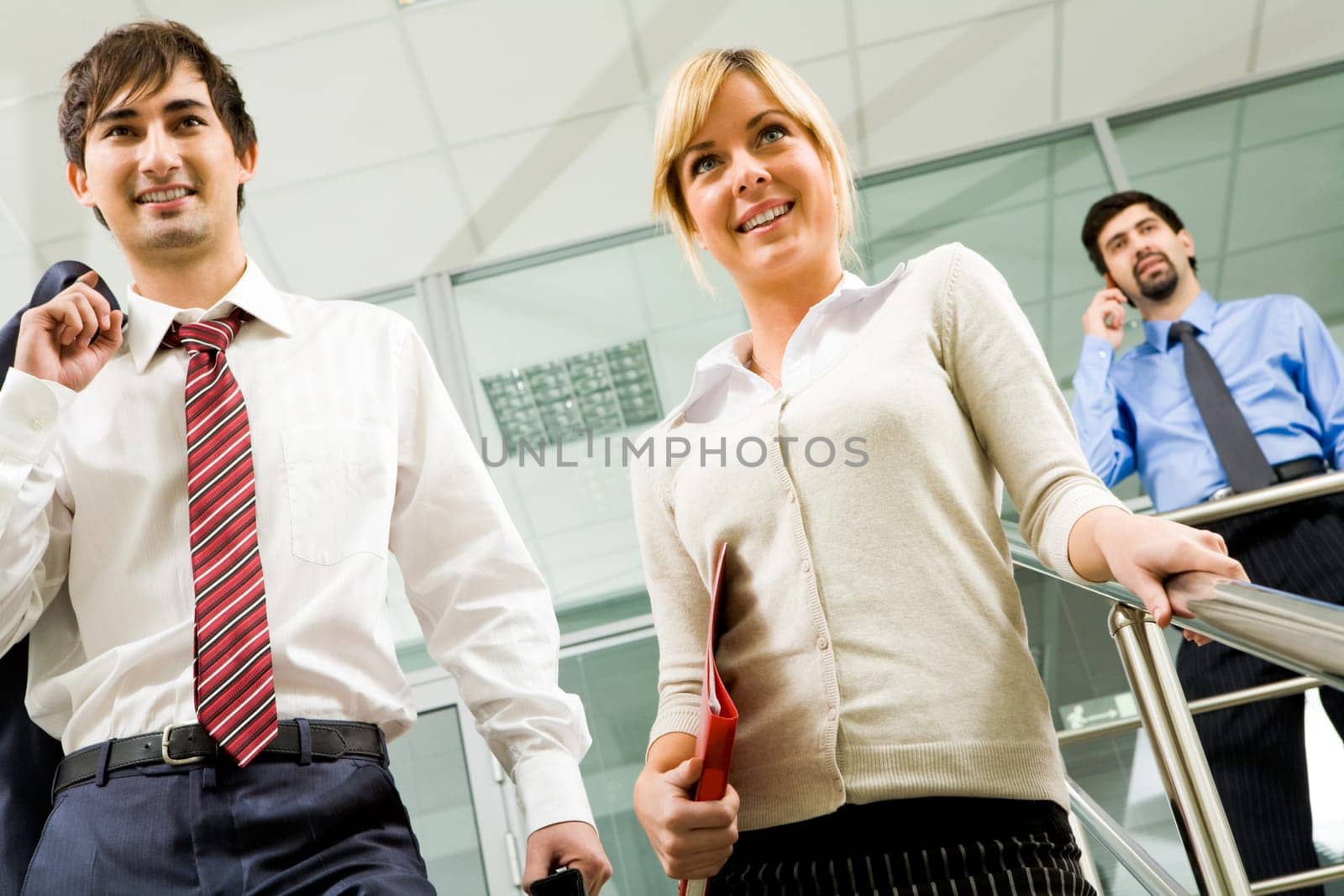 Photo of successful business partners in office building