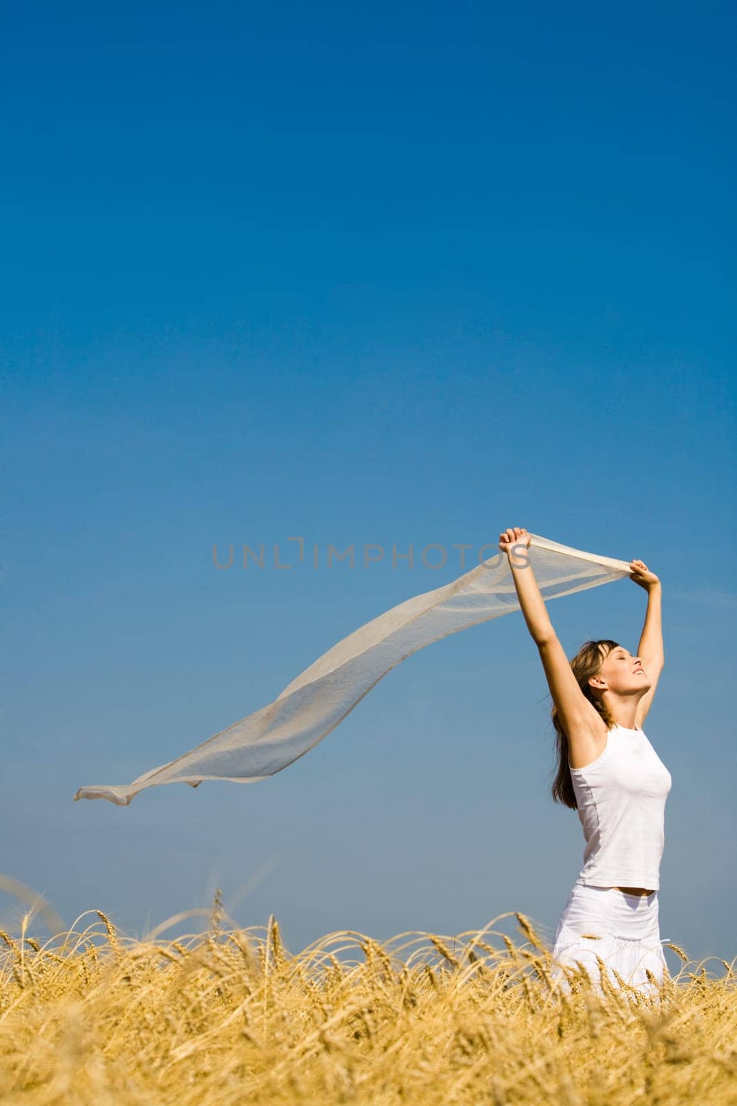 Portrait of attractive girl with fluttering piece of fabric in hands