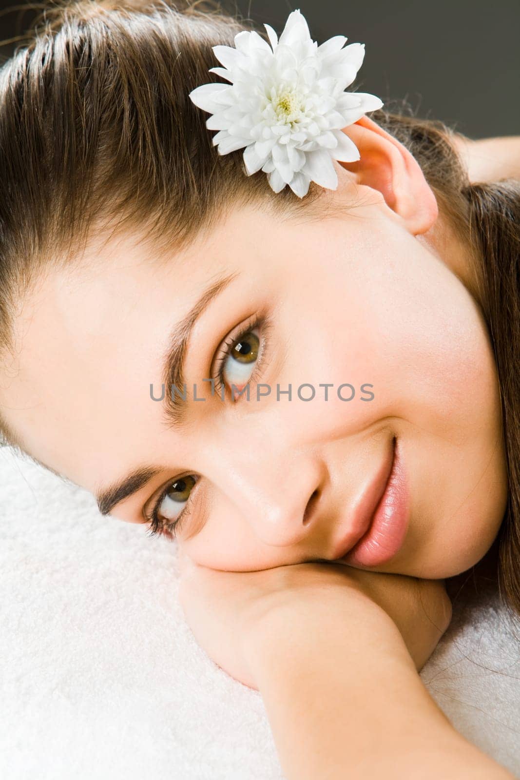 Beautiful smiling woman putting head on her hand