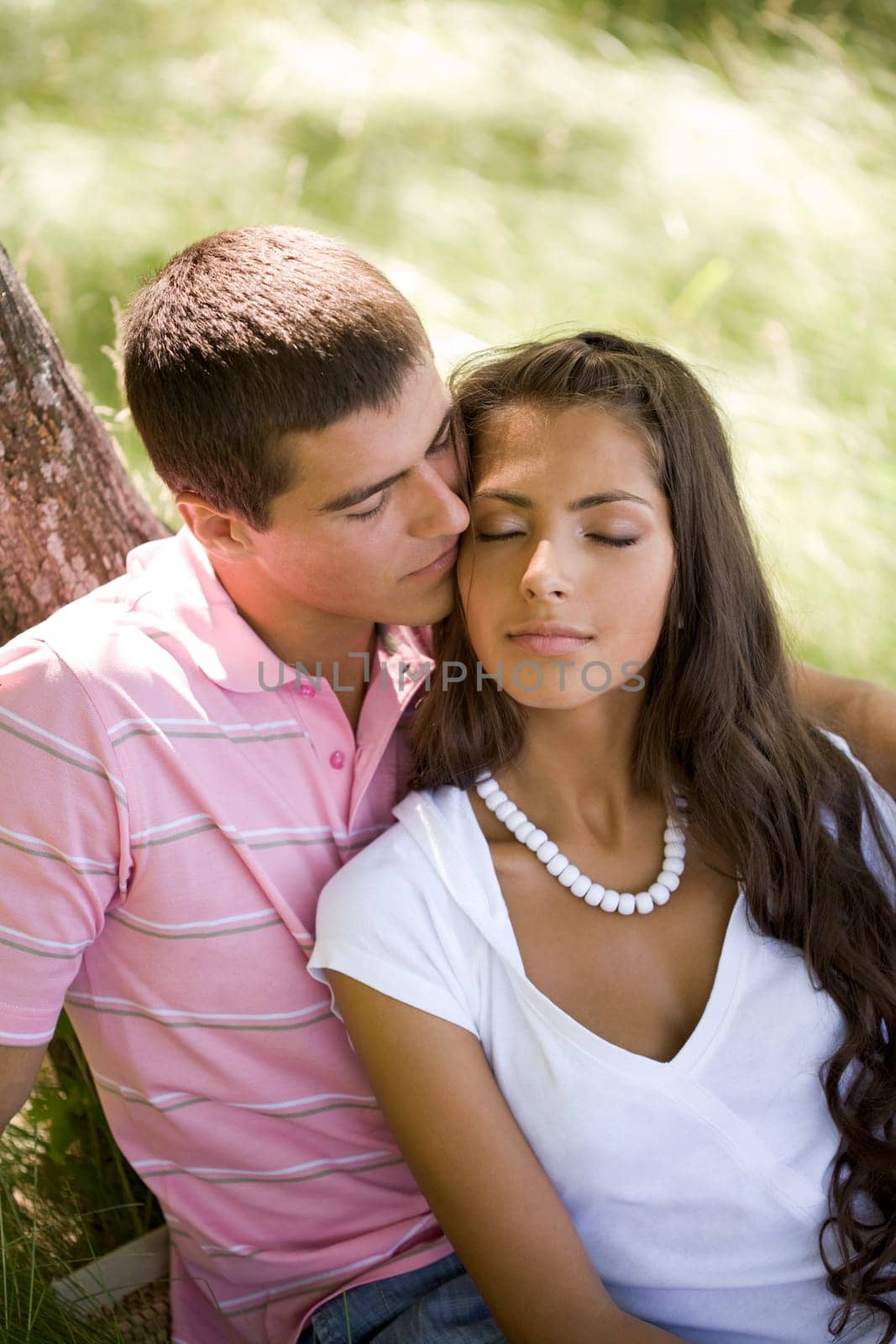 Image of tender man kissing girls face while spending time together