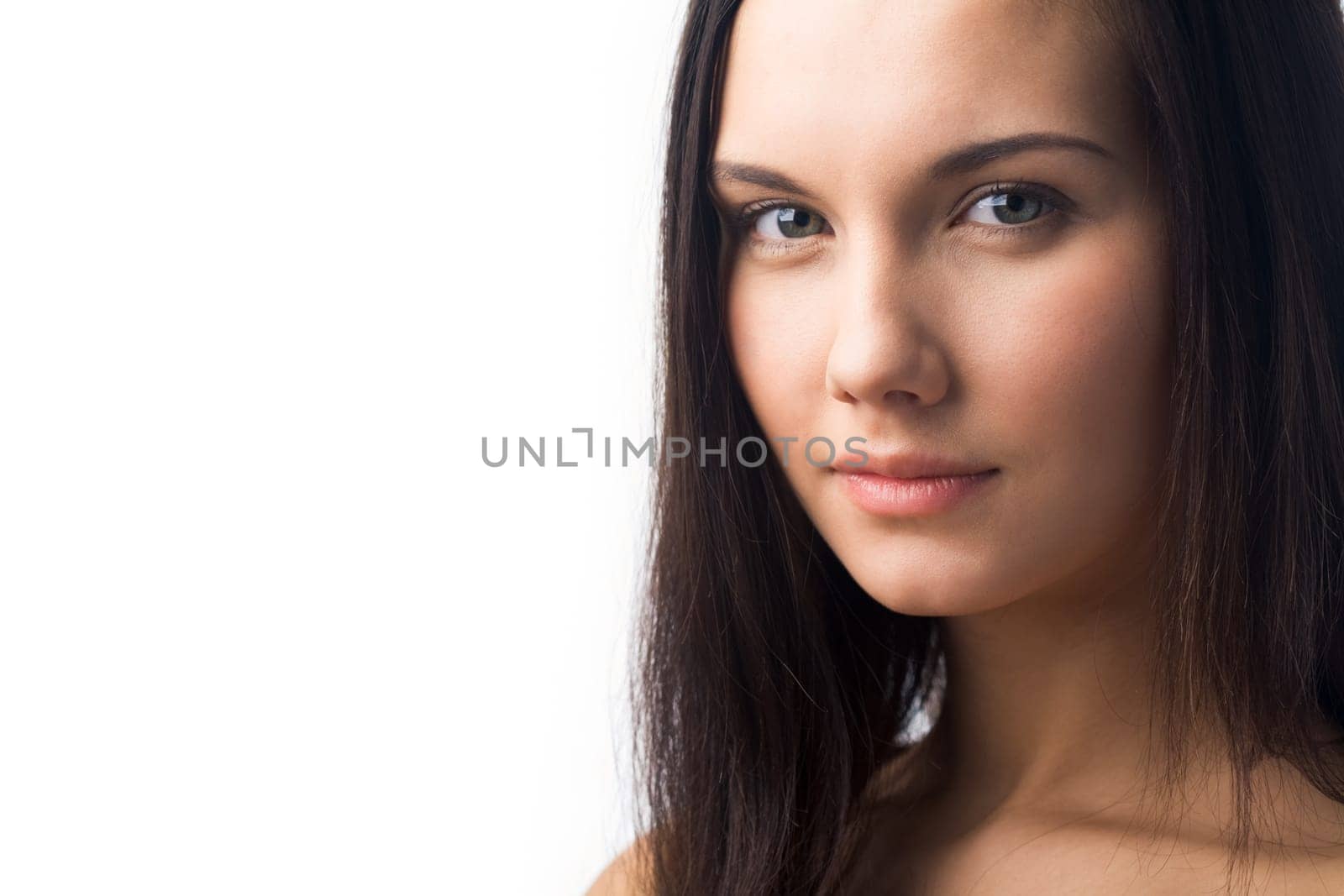 Portrait of charming girl looking at camera over white background