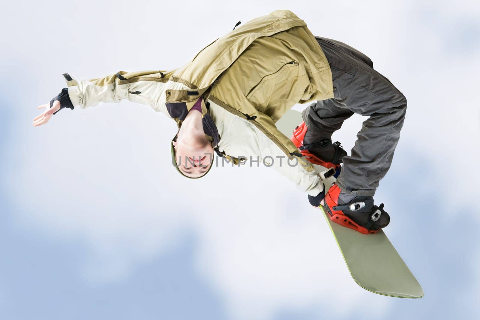 Image of courageous guy jumping on snowboarder in the air