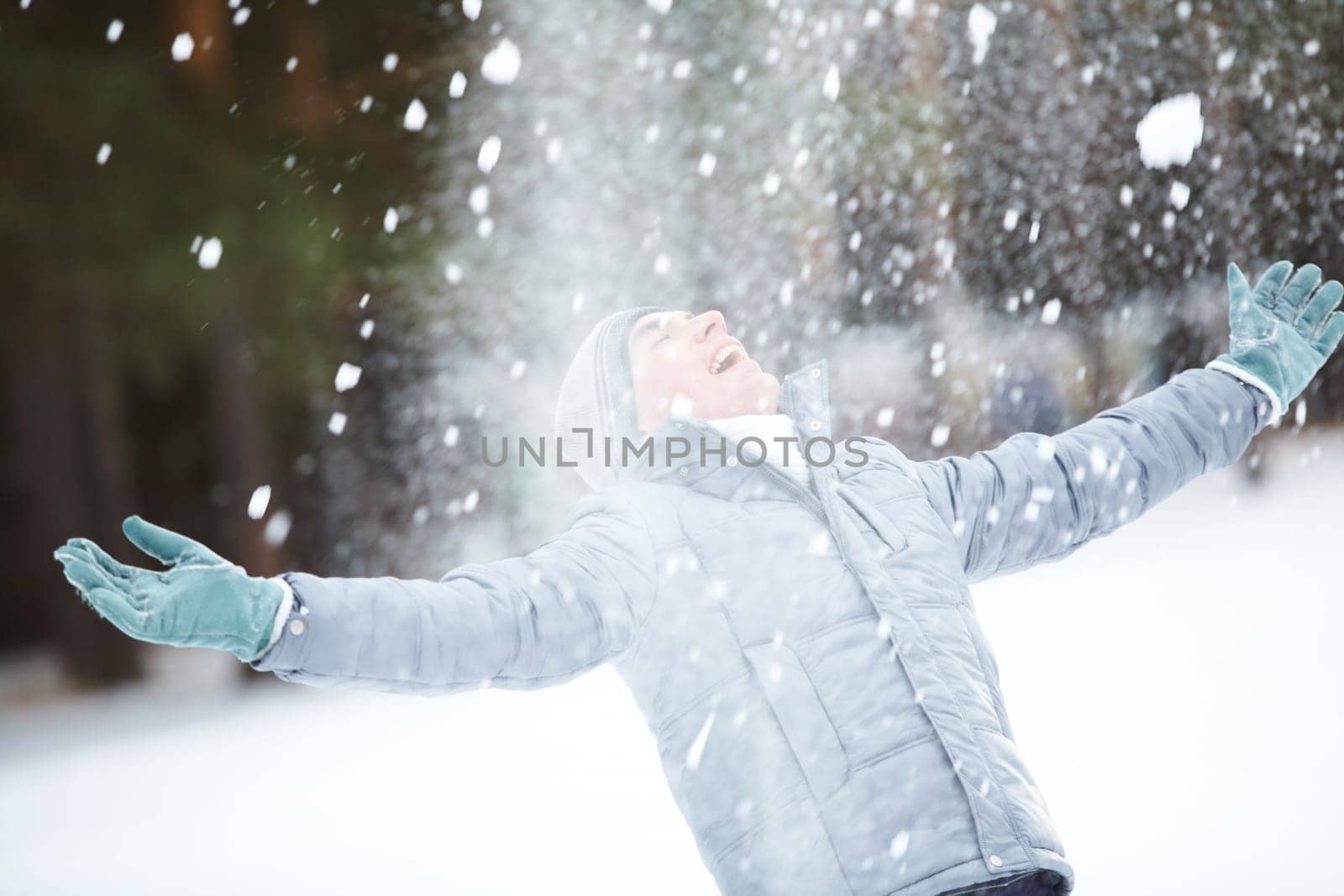 Portrait of cute guy taking pleasure on snowy winter day