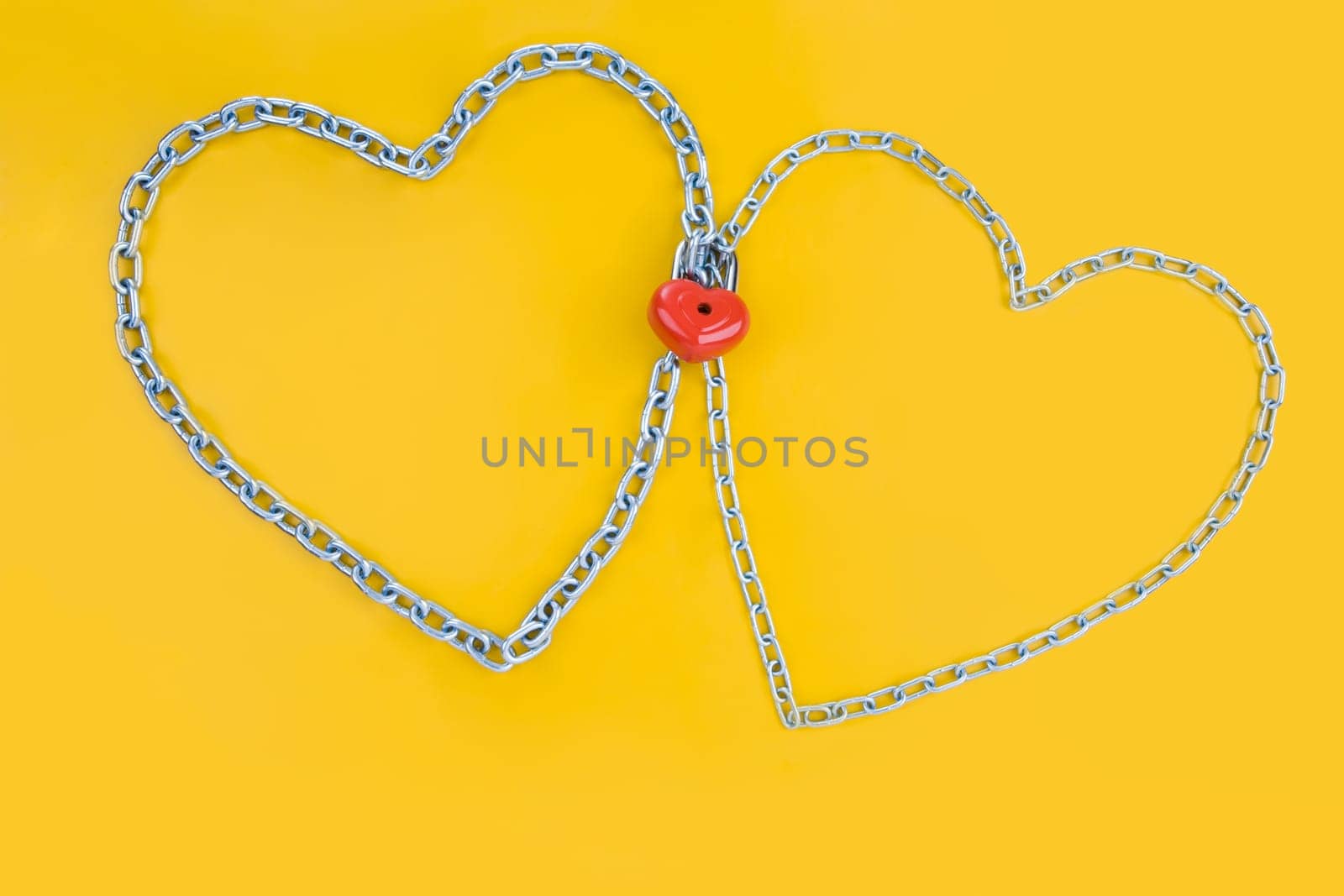 Image of two metallic hearts connected by lock