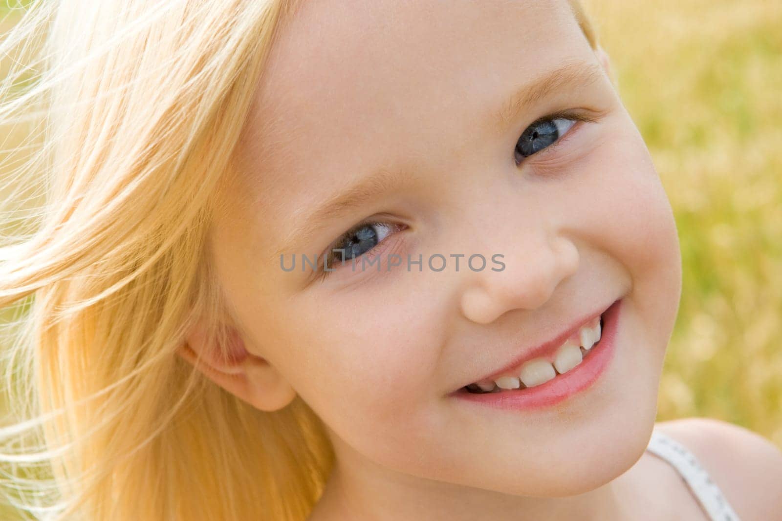 Face of youthful girl looking at camera with smile