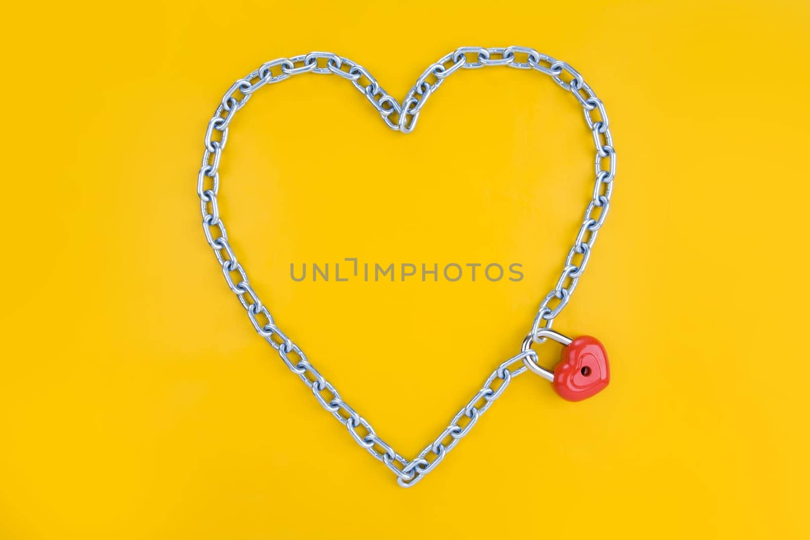 Chain forming heart shape being joined by a lock