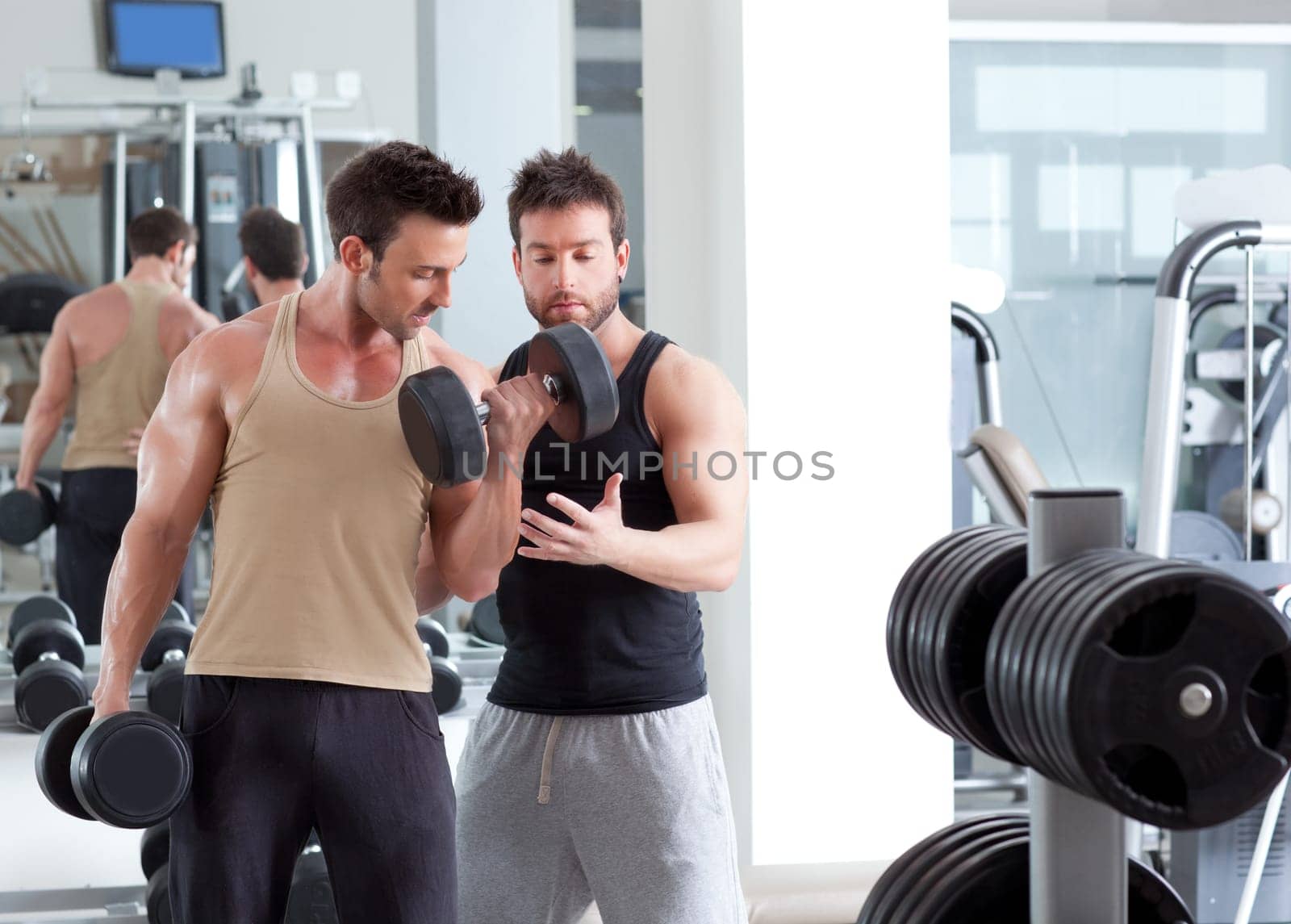 gym personal trainer man with weight training equipment